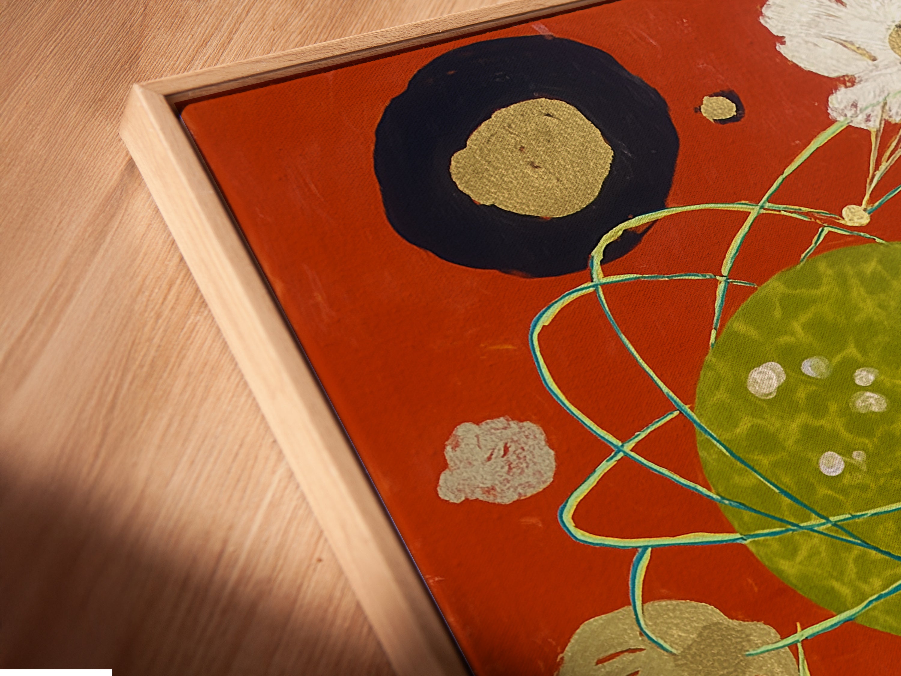 An angled close up shows a cosmic abstract art print in a floating frame. This celestial collage wall art is modern surreal canvas art. The colorful abstract would be a great addition to your living room wall.