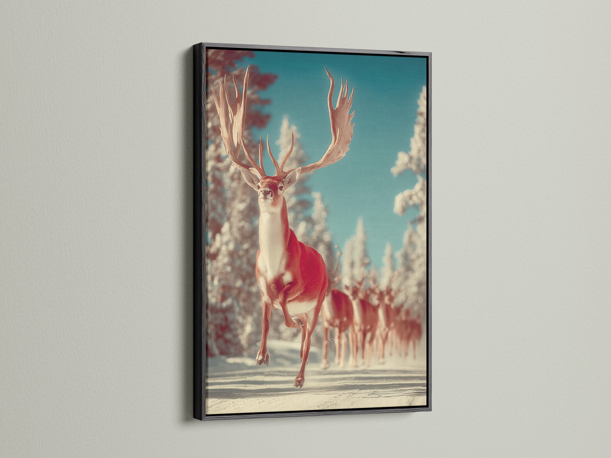 Winter Deer canvas art in a black frame hangs on a white wall. This stag artwork brings forest animal art to your walls. It's a unique wildlife print that captures the essence of winter. A great choice for seasonal decor adding a touch of rustic charm.