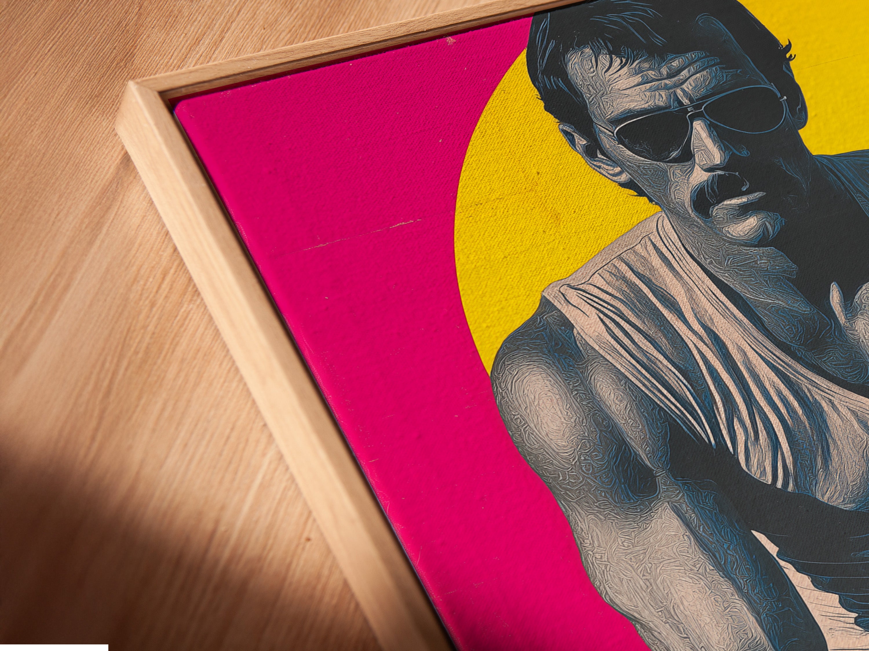 Angled close up of a pop art portrait in a floating frame. Magenta pink and retro style create a vintage man cave aesthetic. This poster is ideal for bedroom wall decor. The canvas print adds a unique touch to mid-century or eclectic styles.
