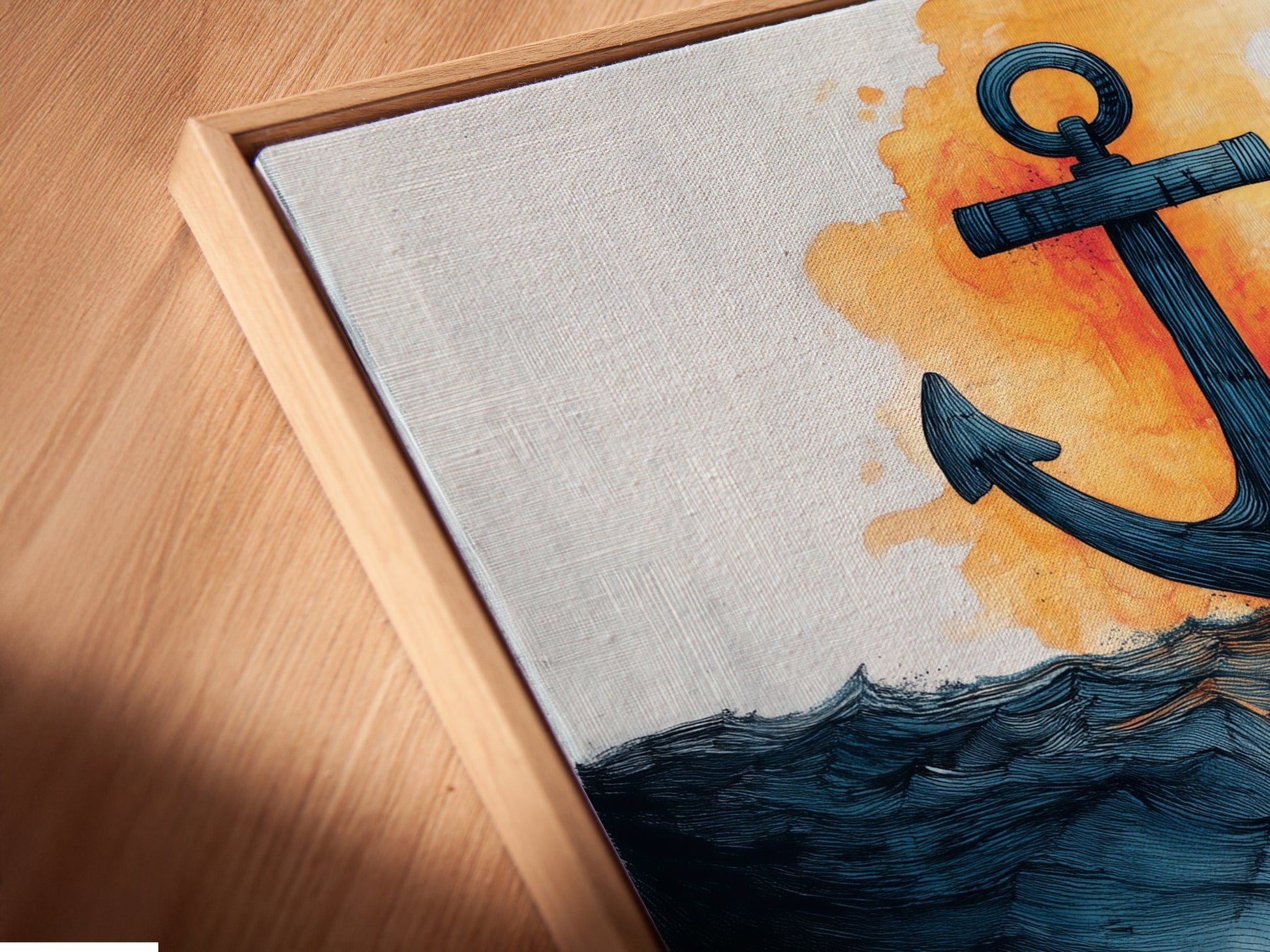 Angled close-up of a canvas print in a floating frame. The art features an anchor and ocean waves. The floating frame gives a modern gallery feel. The art is perfect for coastal style decor. Add a maritime touch to any room.