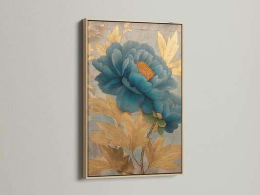 Artwork with an oak frame. The art depicts a blue flower. The artwork is framed in a floating frame. The oak frame is a light brown color. The artwork is hanging on a white wall.