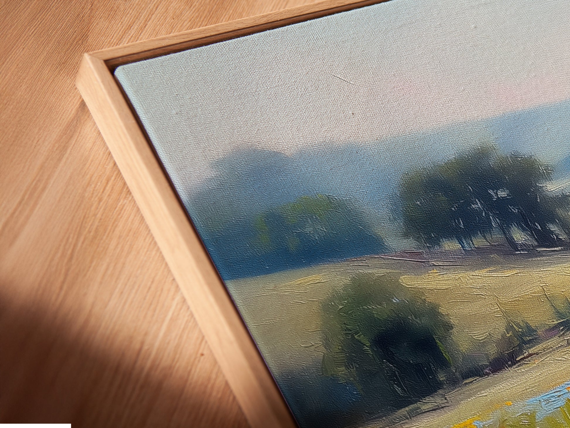 Close-up view of a canvas print of a wildflower meadow in a floating frame. The artwork showcases impressionist details and vibrant colors. The floating frame adds a modern touch to the rustic landscape. Perfect for those seeking elevated wall art for their home or office.