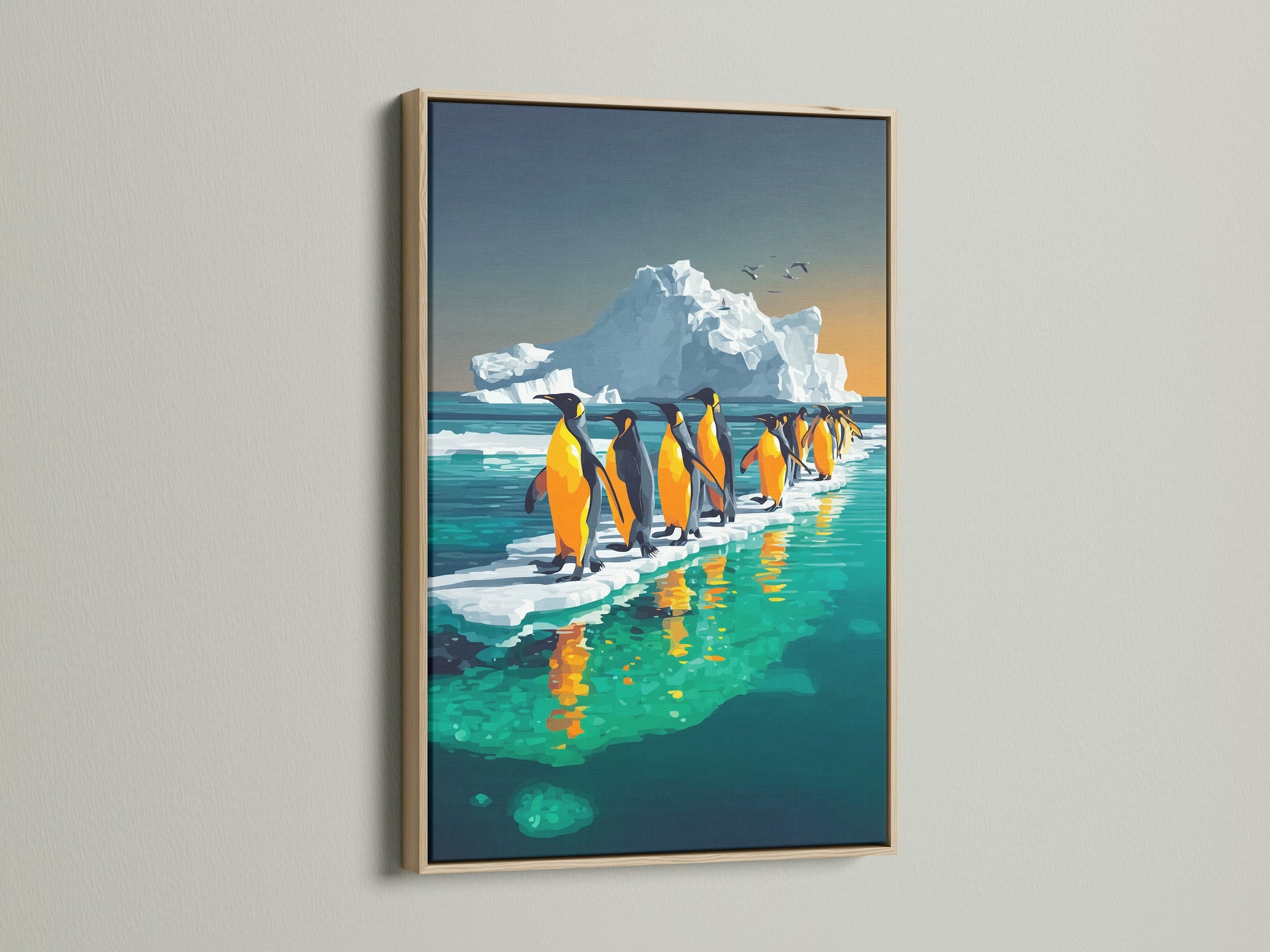 Penguin wall art in an oak frame. The arctic canvas print showcases penguins near an iceberg. This wildlife art print is ideal for adding ocean wall decor to any room. This antarctic animal art is great for a coastal or contemporary style