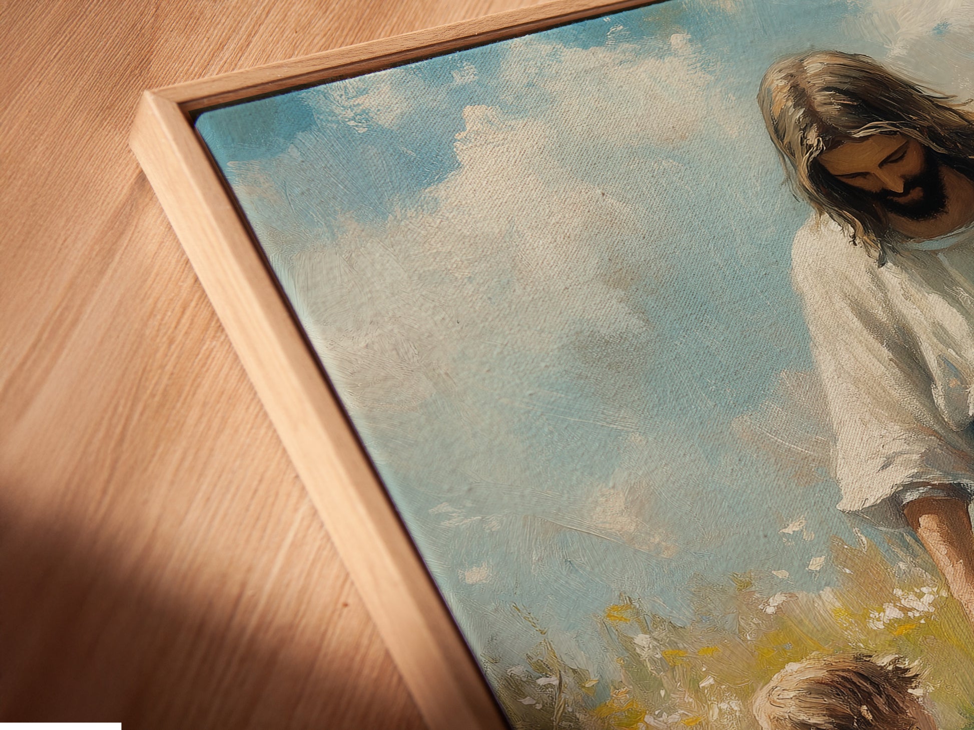 A close-up angled view reveals a canvas print in a floating frame. The art depicts Jesus with two girls. The floating frame gives a contemporary appearance. It makes the art stand out. The canvas texture enhances the image.
