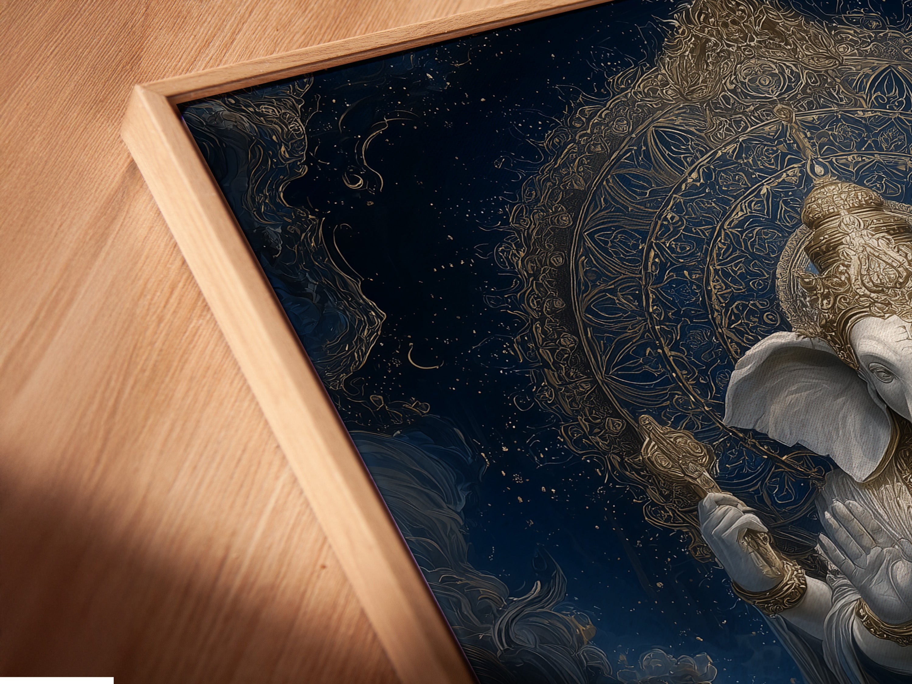 Angled close-up of a Ganesha Canvas Print. It's displayed in a floating frame. This sacred art print enhances any eclectic space. Perfect for yoga instructors and interior designers to create elevated spiritual spaces.