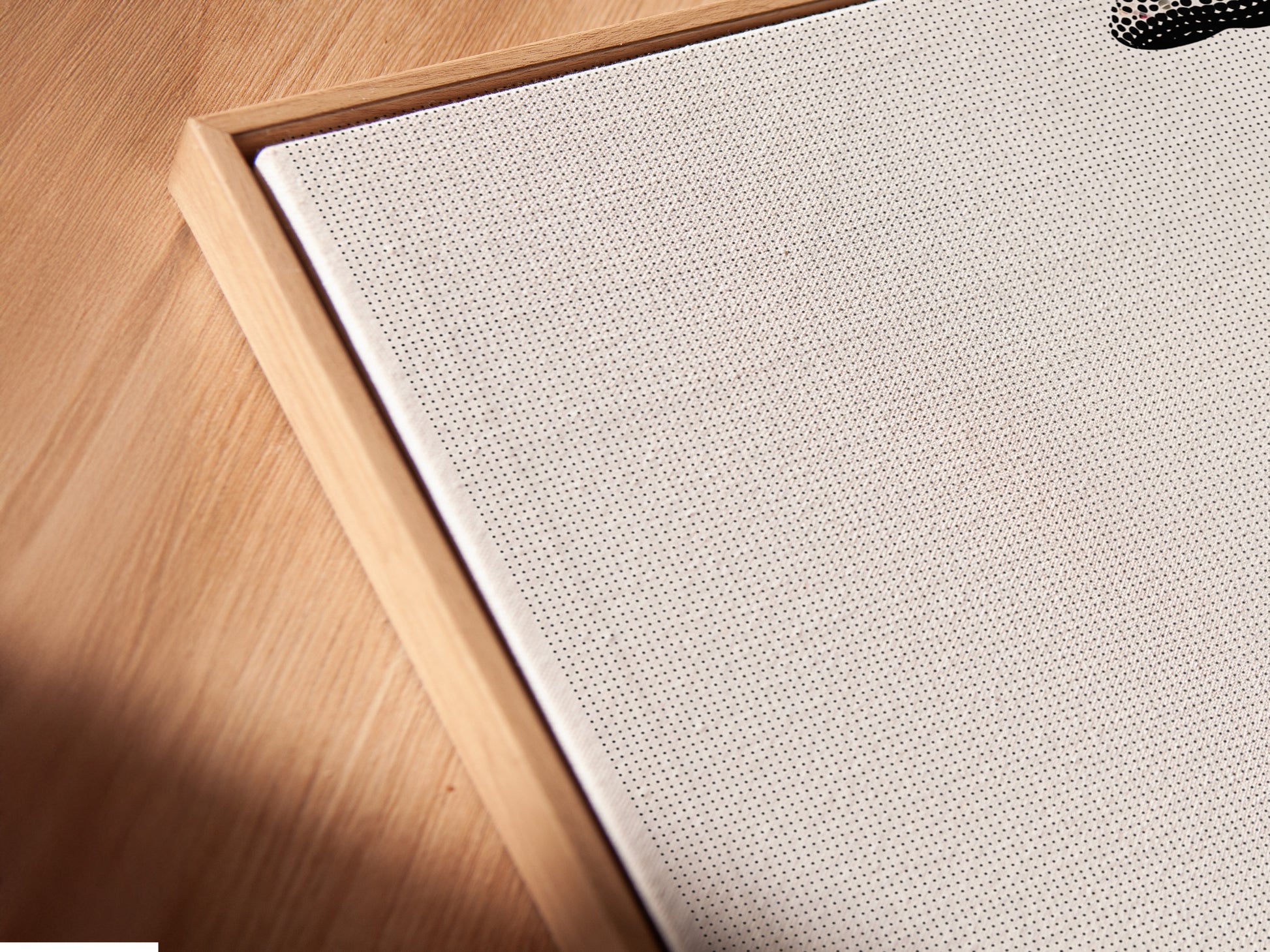 Angled close up of a dinosaur canvas print in a floating frame. This minimalist brontosaurus art is perfect for a kids room. The black and white animal artwork is modern nursery decor.