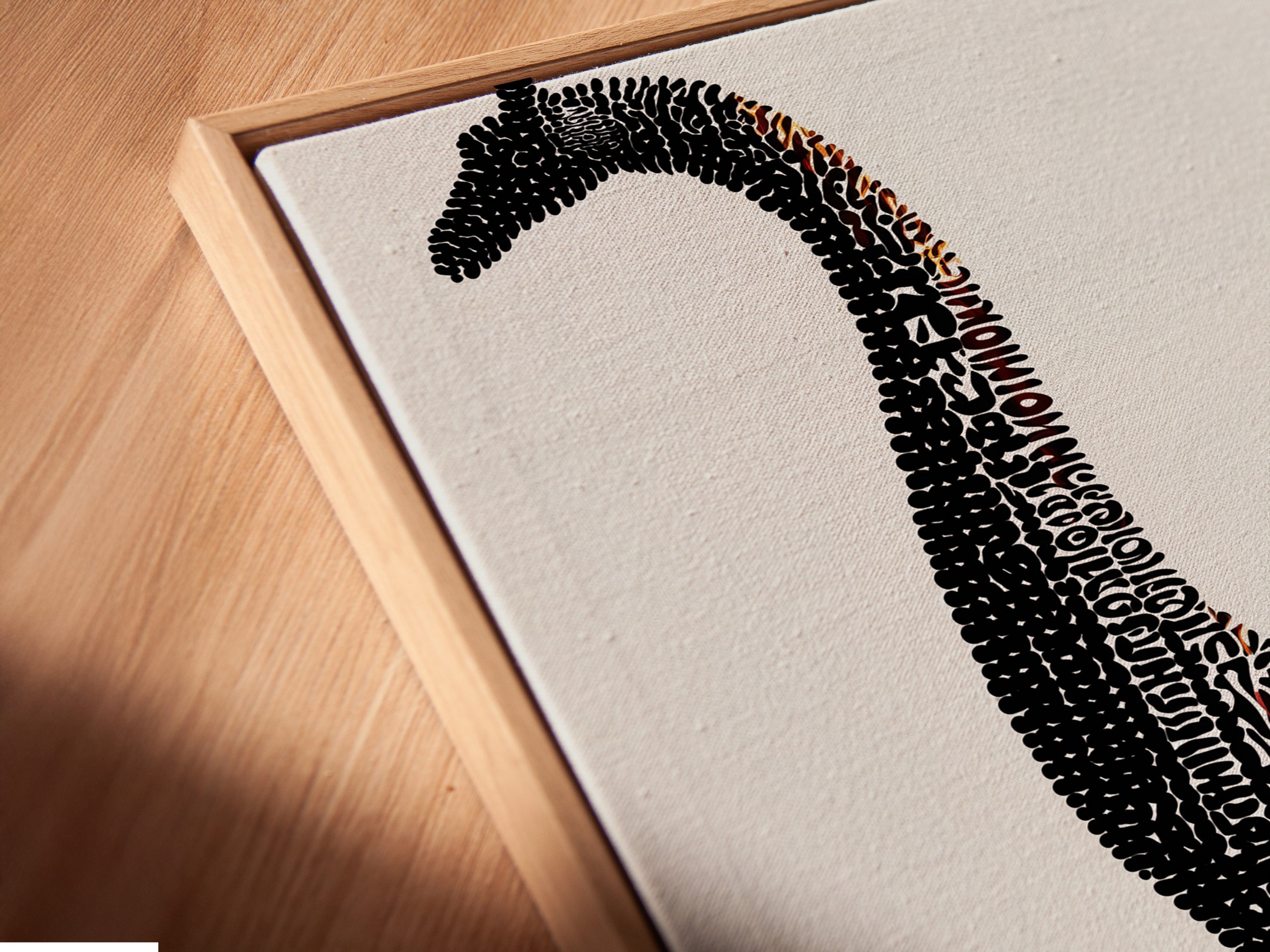 A detailed view of a canvas print in a floating frame. The artwork showcases dinosaur typography. The Brontosaurus word art canvas is a modern piece for a kids room. It's ideal wall decor for a nursery or playroom. The floating frame gives the art depth and prominence.