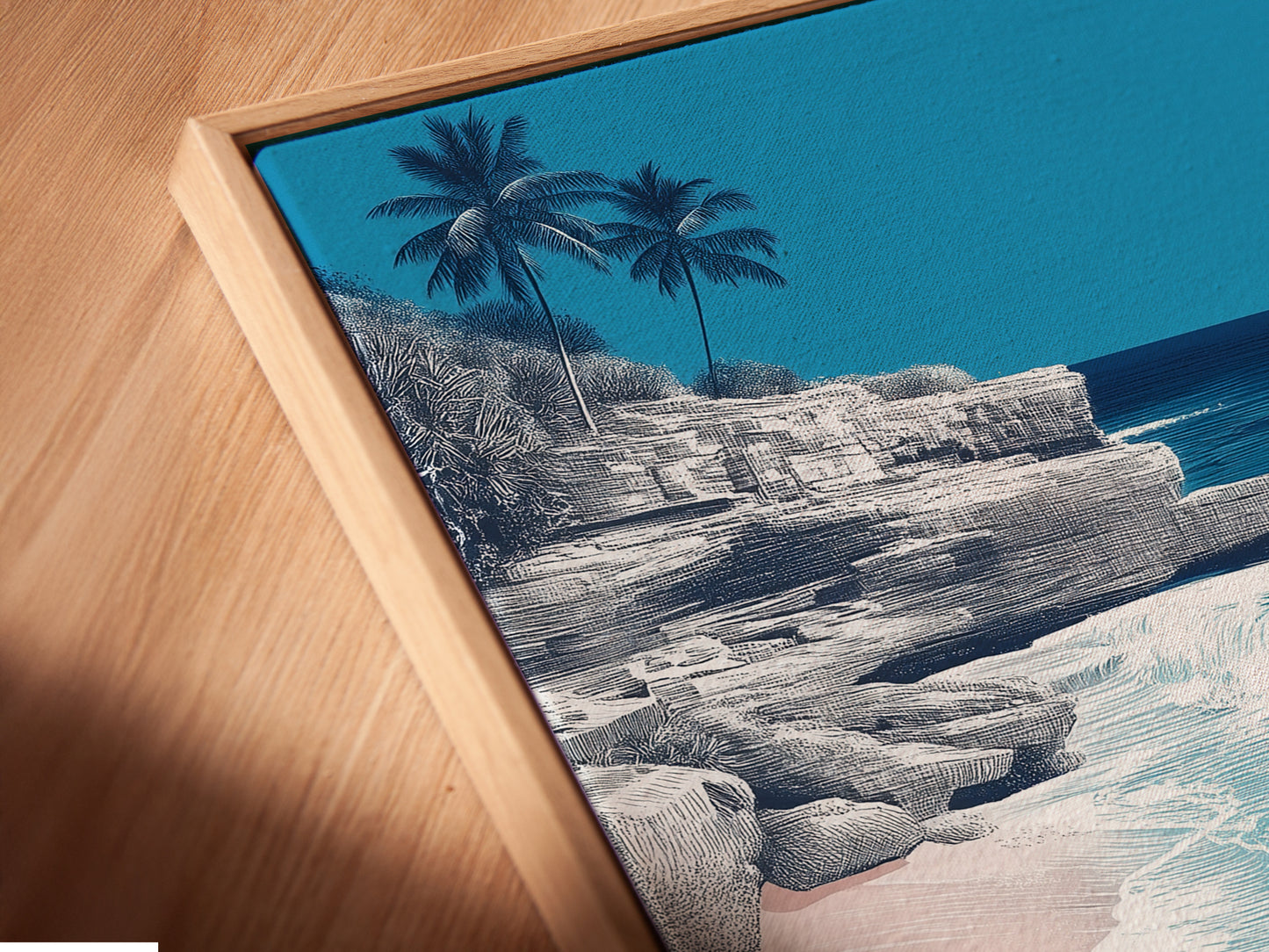 Angled close-up of a canvas print in a floating frame. The artwork showcases a turquoise ocean and coastal landscape. This framing style adds depth to beach artwork. Ideal for modern homes and offices. Order yours today.