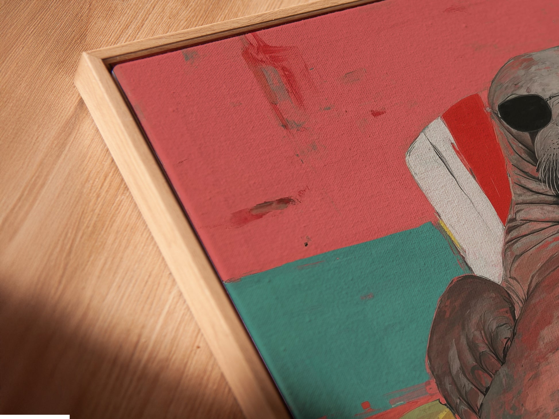 This angled close-up shows a canvas print in a floating frame. It is the Walrus Wall Art Print. This quirky animal art offers retro summer vibes. The art is ideal for beach house decor. The piece adds a unique touch to any room. The floating frame enhances the artwork's modern appeal.