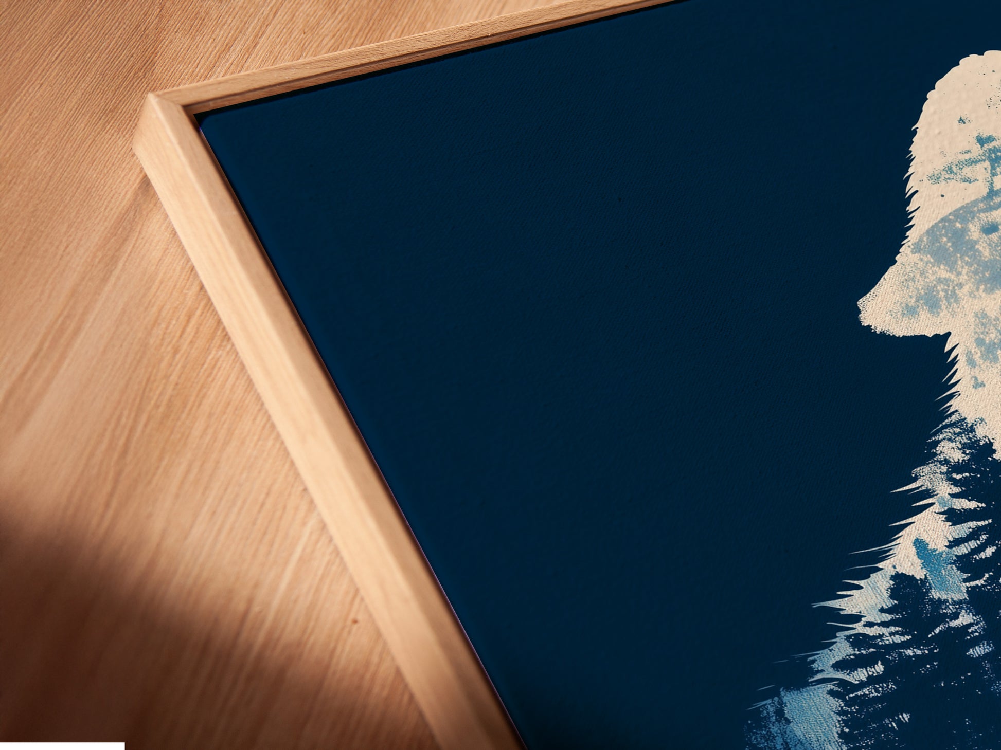 Angled close up of the canvas print in a floating frame. The wolf silhouette art is a nature-inspired piece. The moonlight forest wall art is perfect for bedroom decor. Wilderness canvas for animal wall art.