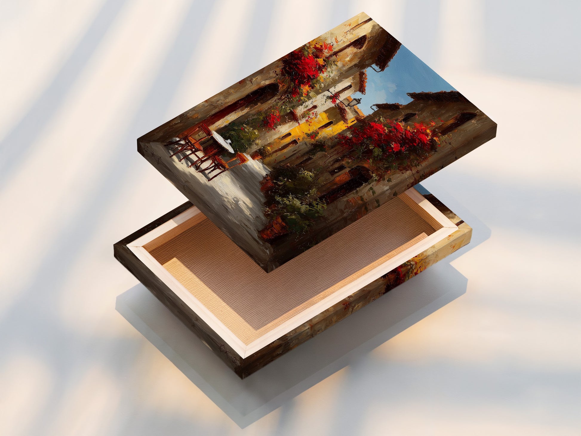 Stretched canvas print of an Italian street scene with red flowers. The canvas is stretched tightly over a wooden frame. The artwork looks vibrant and detailed. This creates a ready-to-hang piece of art. The light highlights the texture of the canvas.