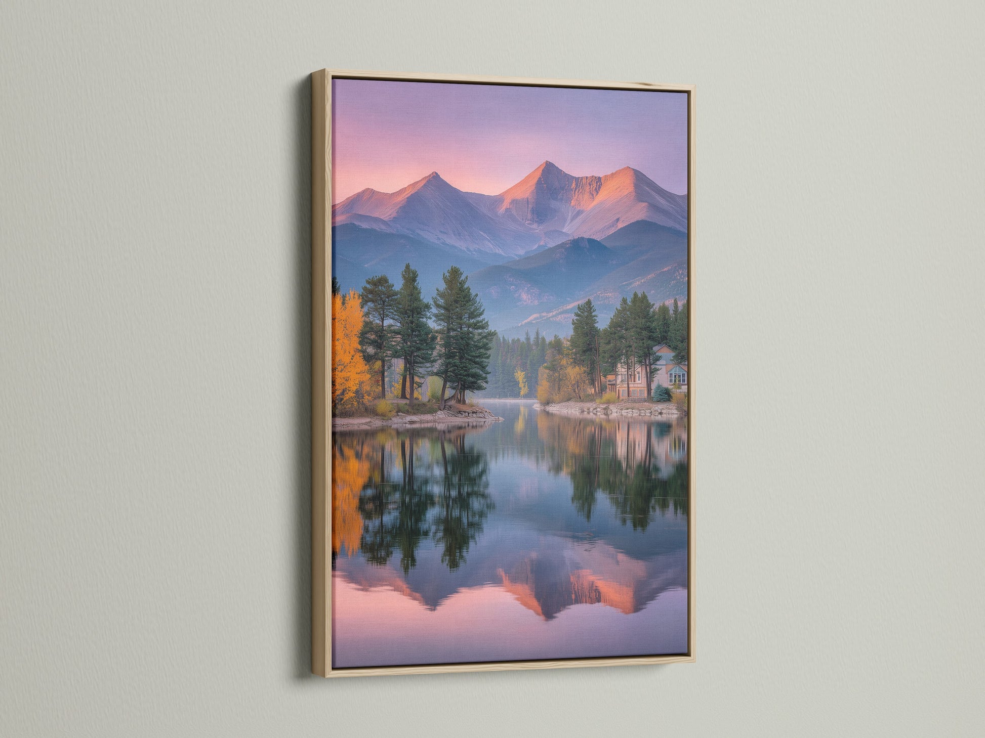 Experience the beauty of nature with this mountain lake canvas art. The artwork is framed in a natural oak frame. The pink sunset reflects perfectly on the lake. Bring wilderness art into your home with this serene piece.