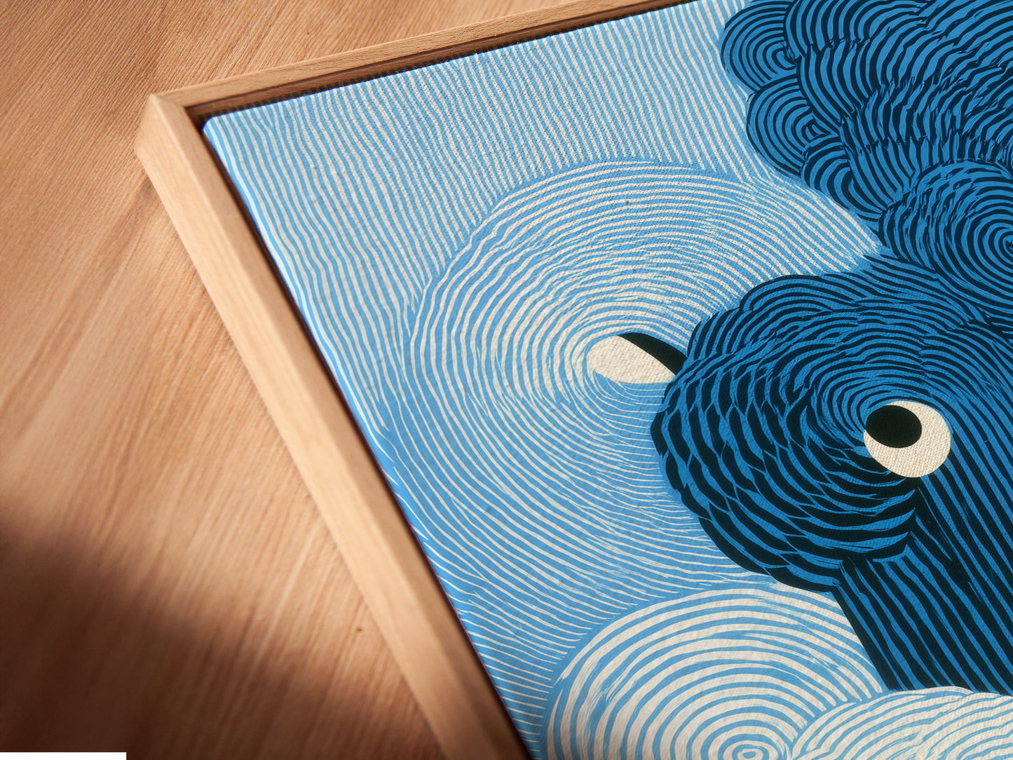 A close-up angled view shows a canvas print in a floating frame. The abstract wave artwork highlights the modern swirl art. The blue ocean print appears to float. This framing style adds depth and dimension. The piece enhances your home decor effortlessly.