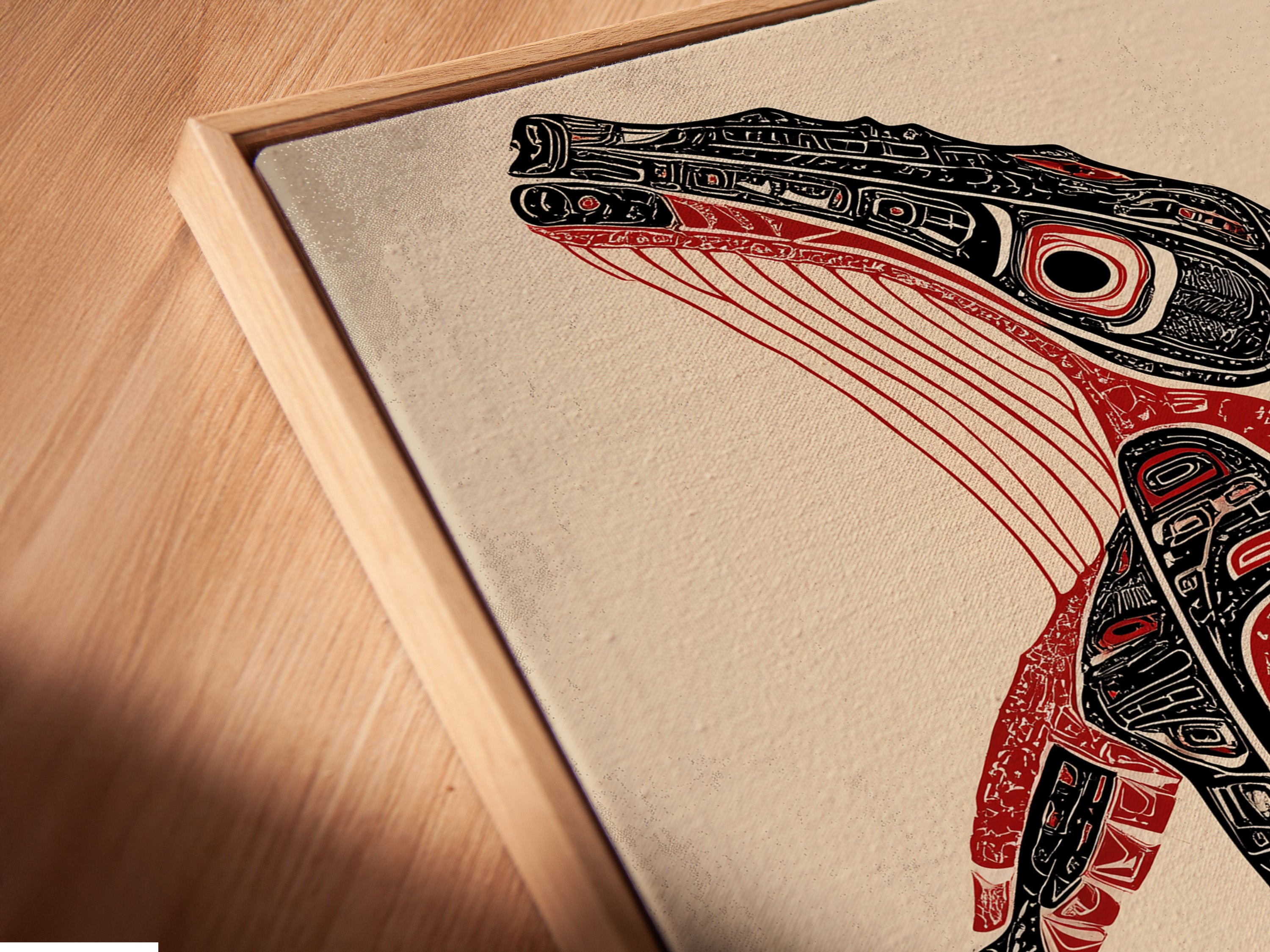 Close up of a canvas print in a floating frame. The Pacific Northwest native artwork appears to hover. A unique way to display tribal wall art. It adds sophistication to office decor.