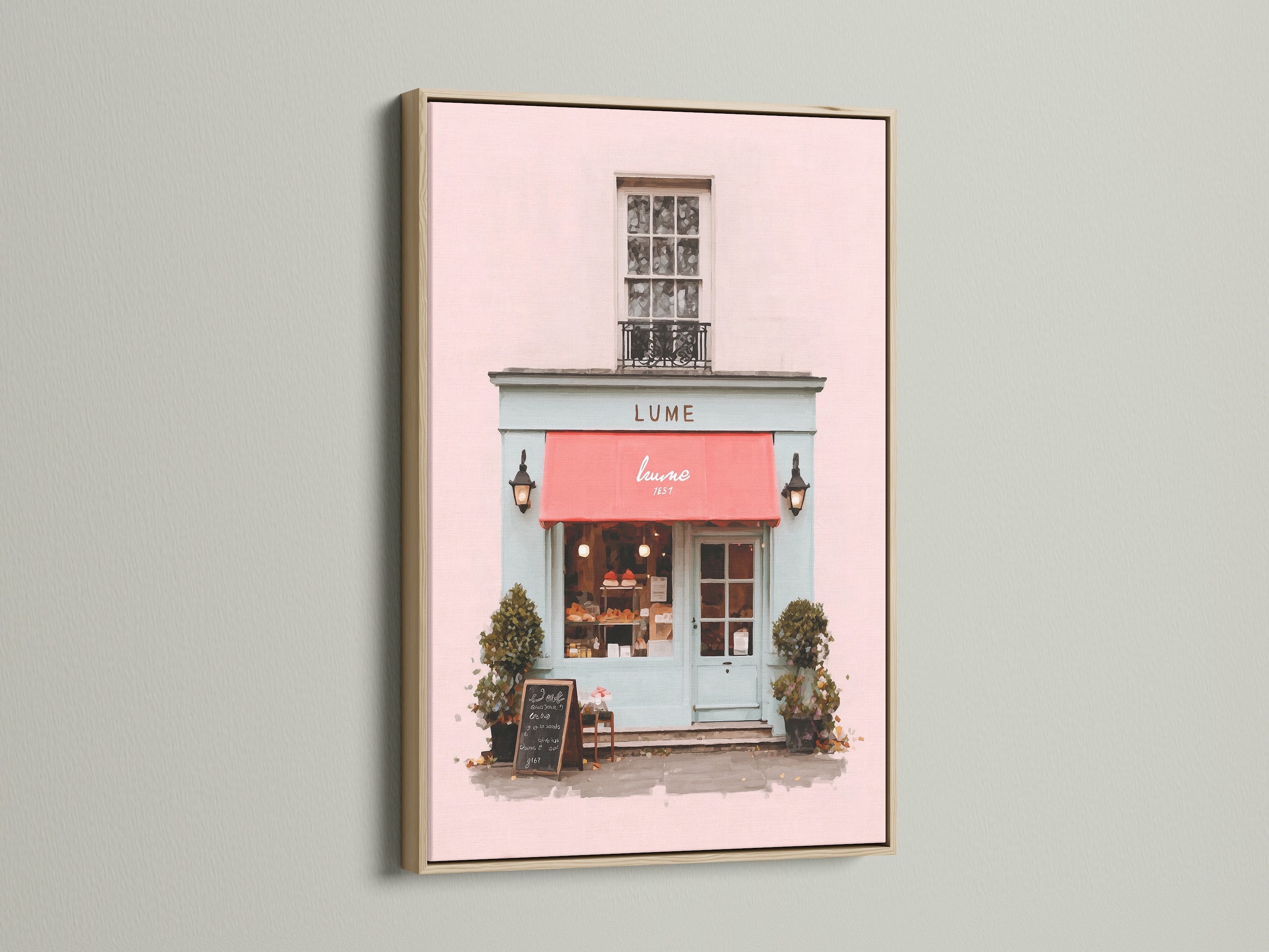 A delightful art print is showcased in an oak frame. The artwork captures a charming shop front with a pink exterior and a vibrant red awning. The oak frame enhances the artwork's warmth. This piece brings a touch of elegance to your home decor with its classic and refined style.