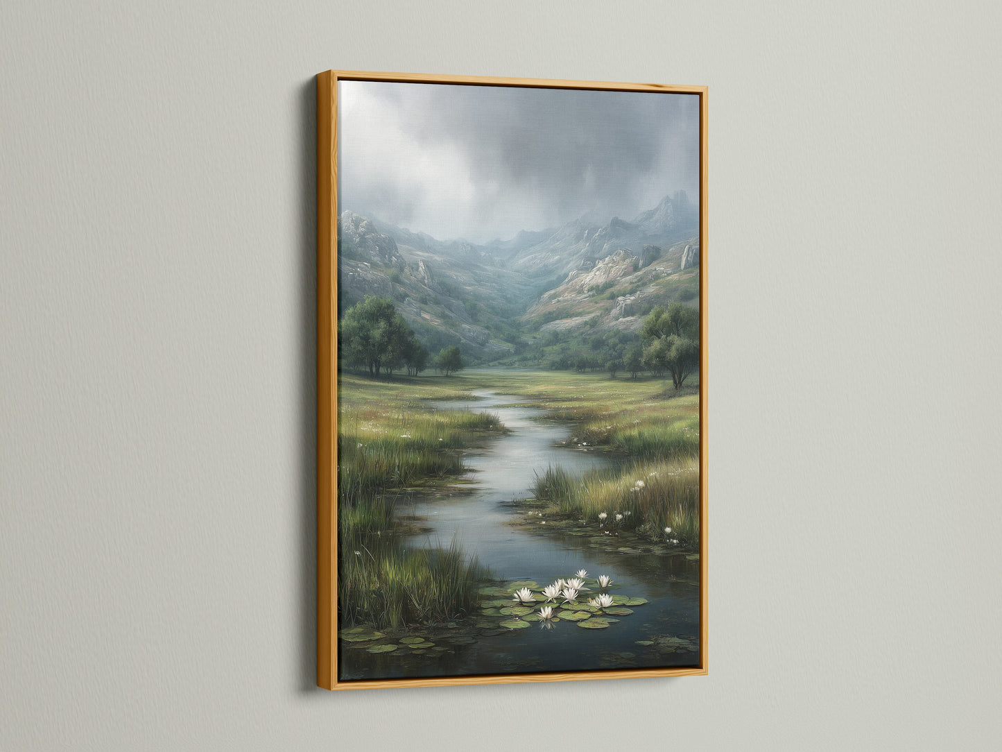 A gold frame adds a touch of elegance to a landscape artwork. The art print shows a river with water lilies in a valley setting. The gold frame enhances the artwork's colors. It brings a sense of luxury to the white wall. This combination creates a refined and stylish display.