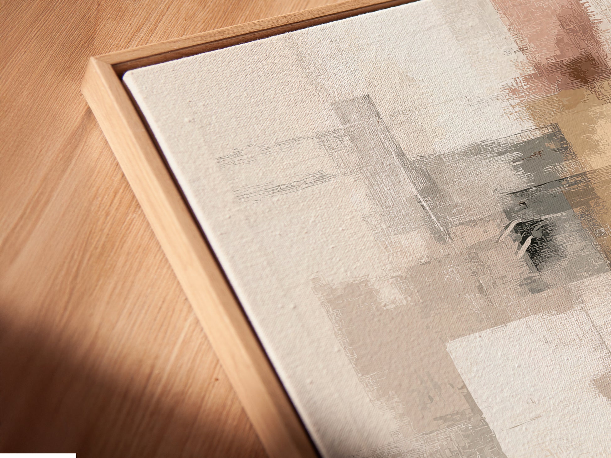A close-up angled view shows a canvas print in a floating frame. The abstract artwork has neutral blush pink and gray tones. This modern minimalist print is great for bedroom wall decor. The floating frame adds a contemporary touch. Perfect for a modern living space.
