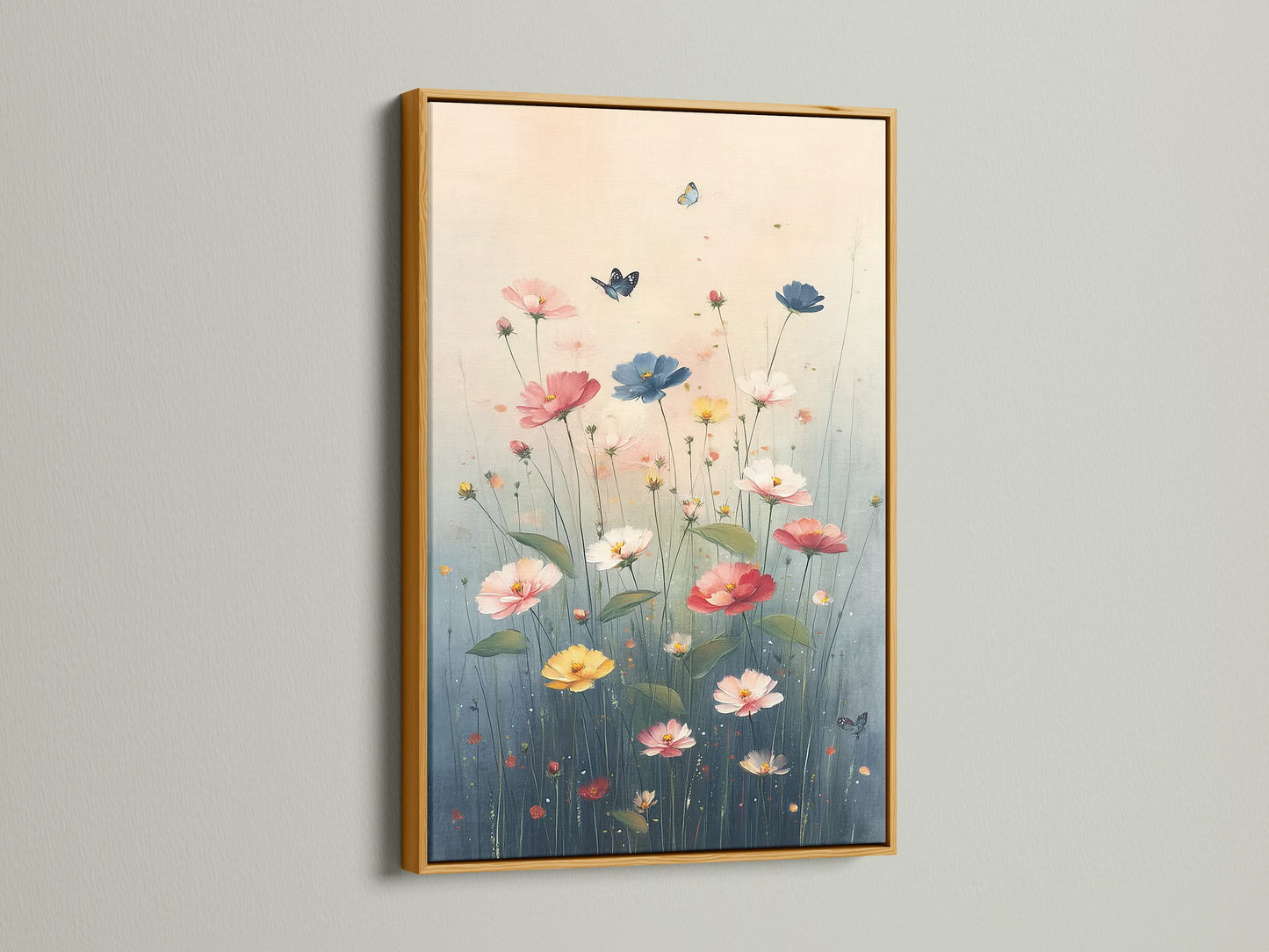 Floral Meadow artwork with a gold frame adorning a white wall. The artwork features wildflowers in a pastel botanical setting. Butterflies add a touch of whimsy. The gold frame enhances the artwork's elegance. This canvas print brings a luxurious feel to your bedroom or living room. It is perfect for spring decor.