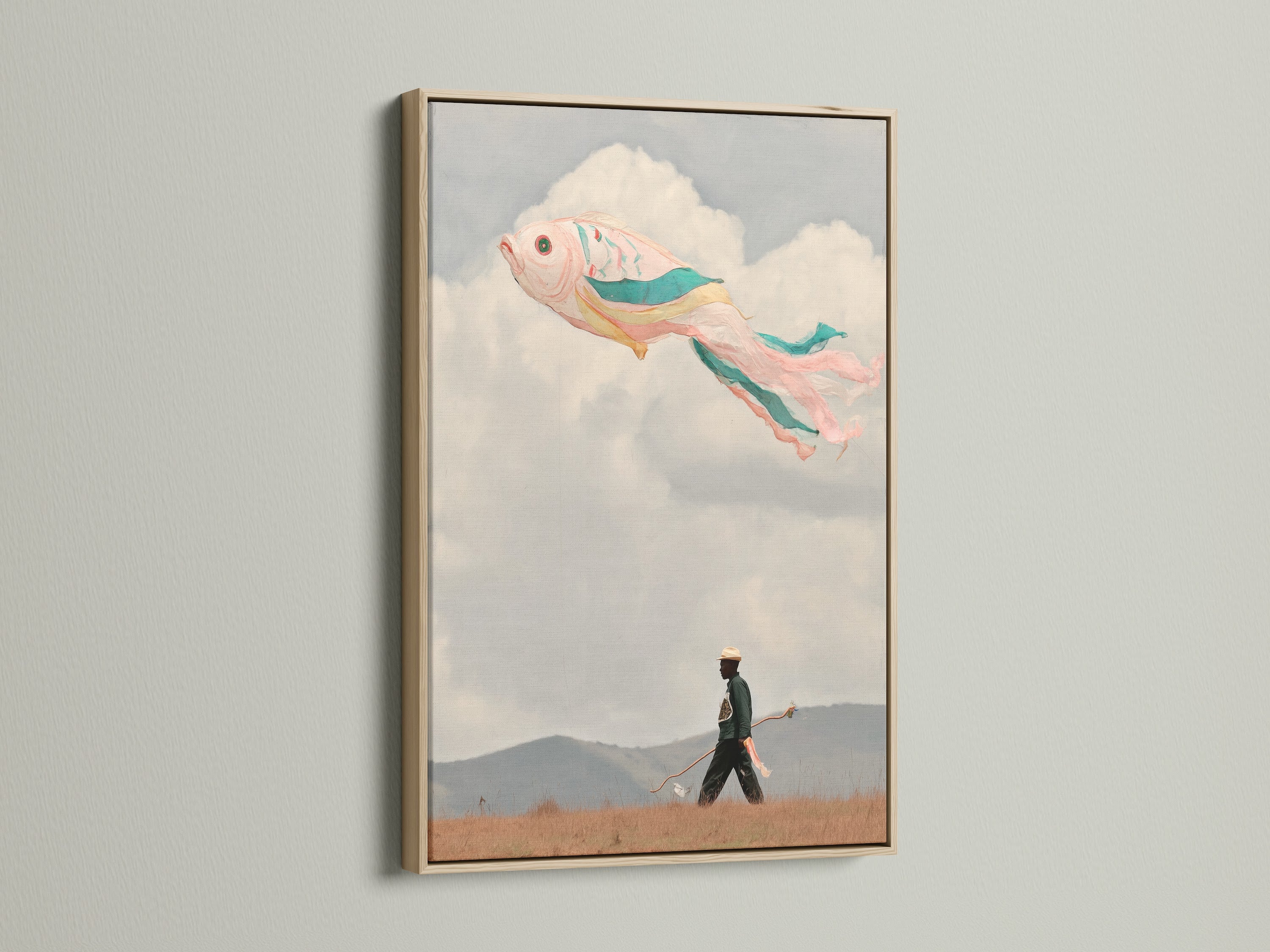A fish kite art print in an oak frame hangs on a white wall. The surreal artwork features a whimsical illustration. This dreamy wall decor is ideal for kids rooms and eclectic styles.