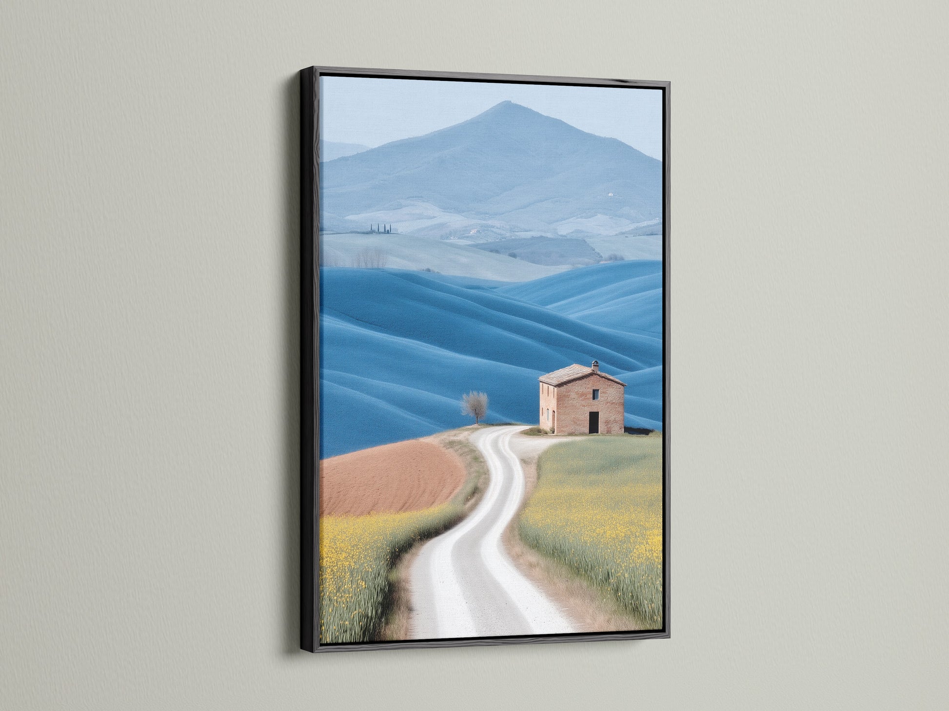 Tuscan Landscape canvas print in a black frame. The black frame adds a touch of sophistication to this farmhouse scenery photograph. The contrast enhances the rolling hills art. Perfect for creating a focal point in any room. This landscape canvas is a great addition to your wall art collection.