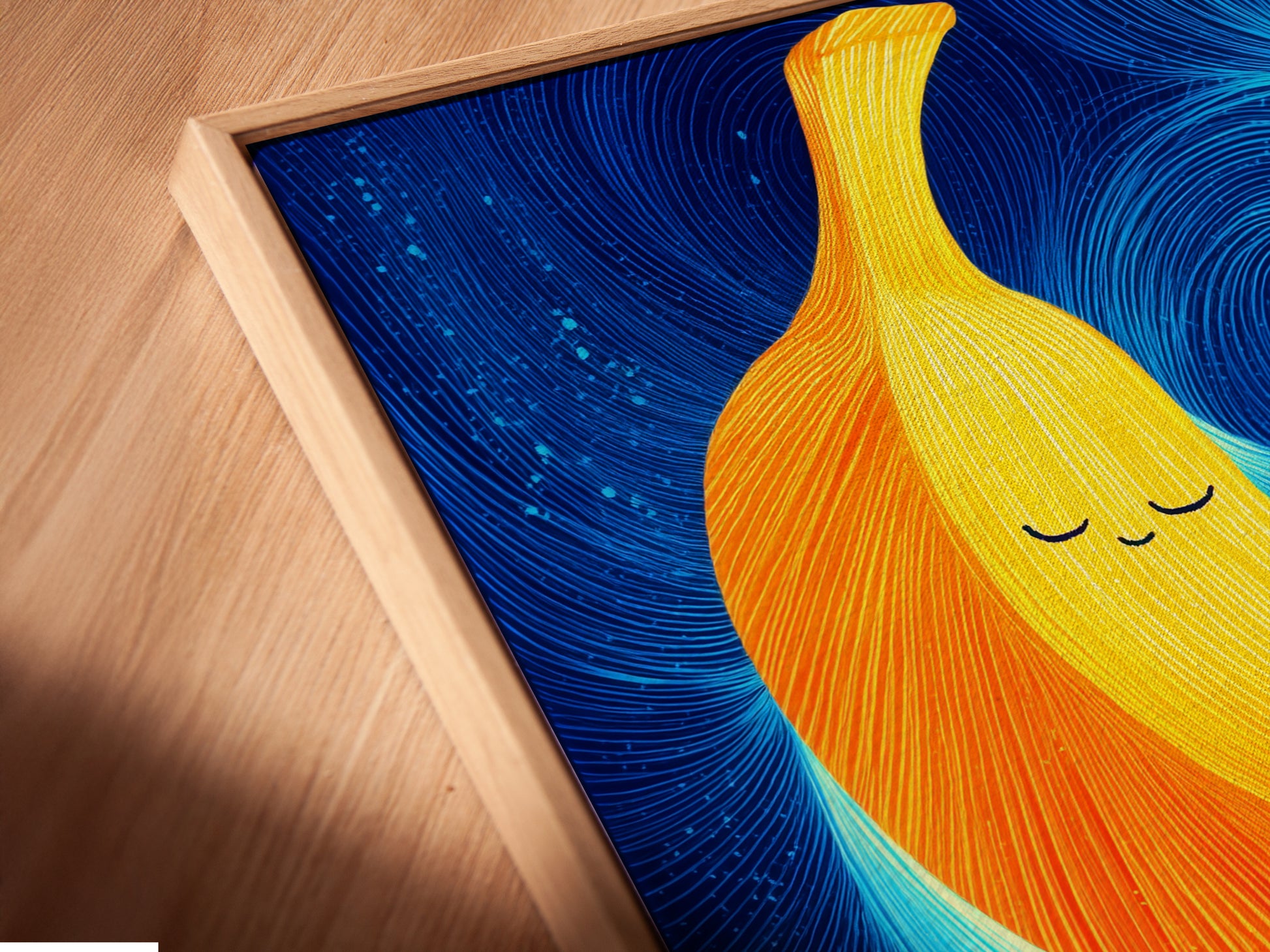 A close-up angled view showcases a Banana Family Canvas artwork print in a floating frame. This cute artwork is perfect for kids room decor. The abstract print adds a playful touch. It is a modern art print.