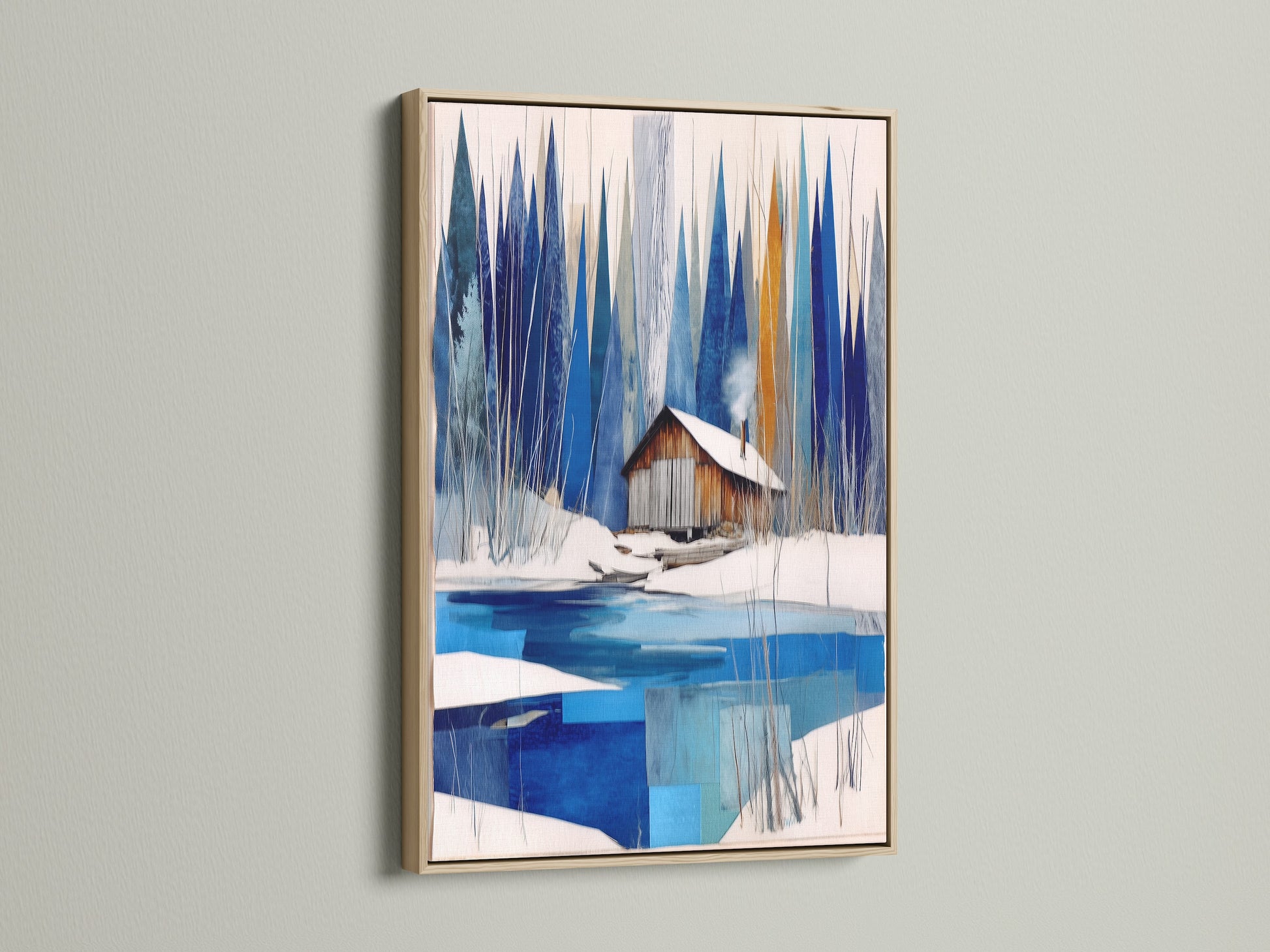 Winter Cabin Canvas Artwork with an oak frame. A serene snowy lake is depicted in this wall art. This piece is perfect for chalet decor. The oak frame adds a rustic touch to the blue and white abstract winter art. A modern wall art choice for nature print lovers and lake house decor.