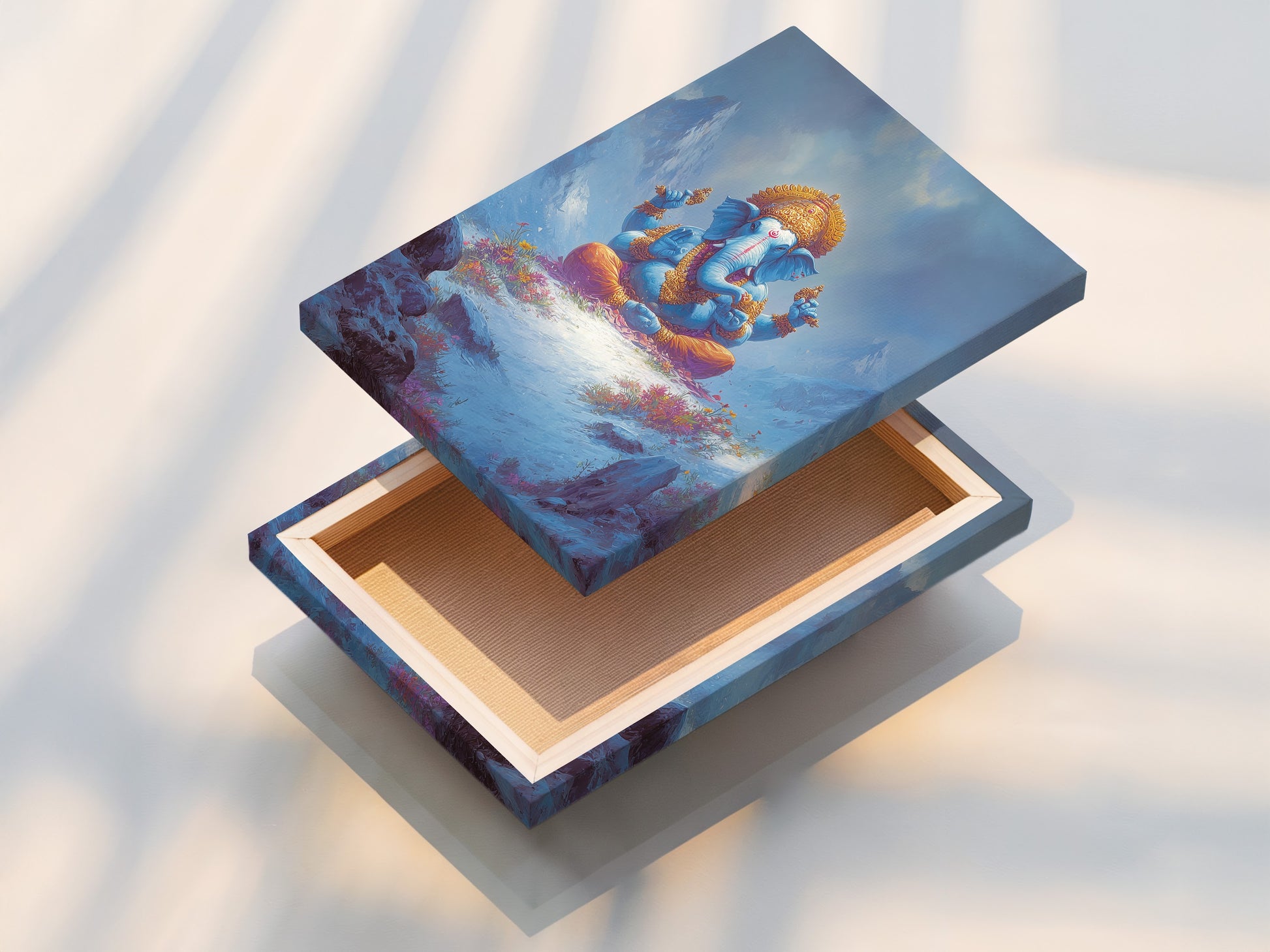 A stretched canvas print featuring Ganesha. This Hindu God artwork is ready to hang. The canvas brings spiritual peace to any room. Perfect for meditation rooms and yoga studios. The blue and gold colors enhance healing centers.