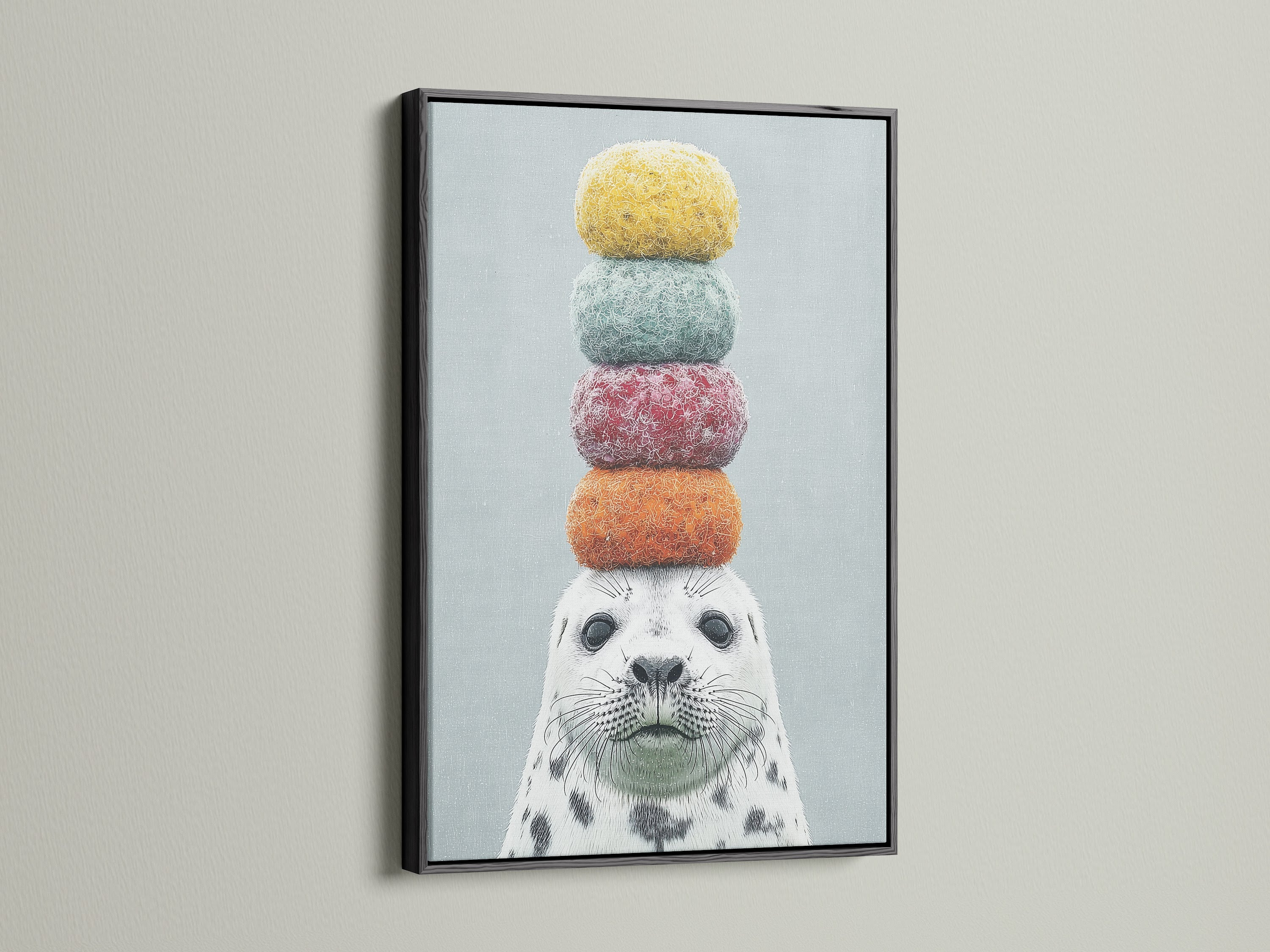 Framed whimsical seal artwork with colorful macarons on its head. The art is presented in a modern black frame. A fun and quirky addition to any space. This animal canvas art is ideal for kids rooms or coastal themed decor. Explore our playful art print collection.