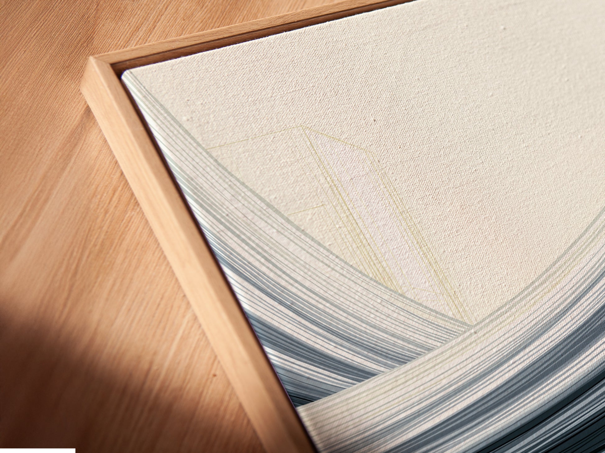 A close-up angled view reveals the texture of a canvas print. The floating frame enhances the abstract cityscape artwork. This modern piece adds depth and sophistication. Perfect for minimalist and contemporary interiors. Elevate your home or office decor with this unique print.