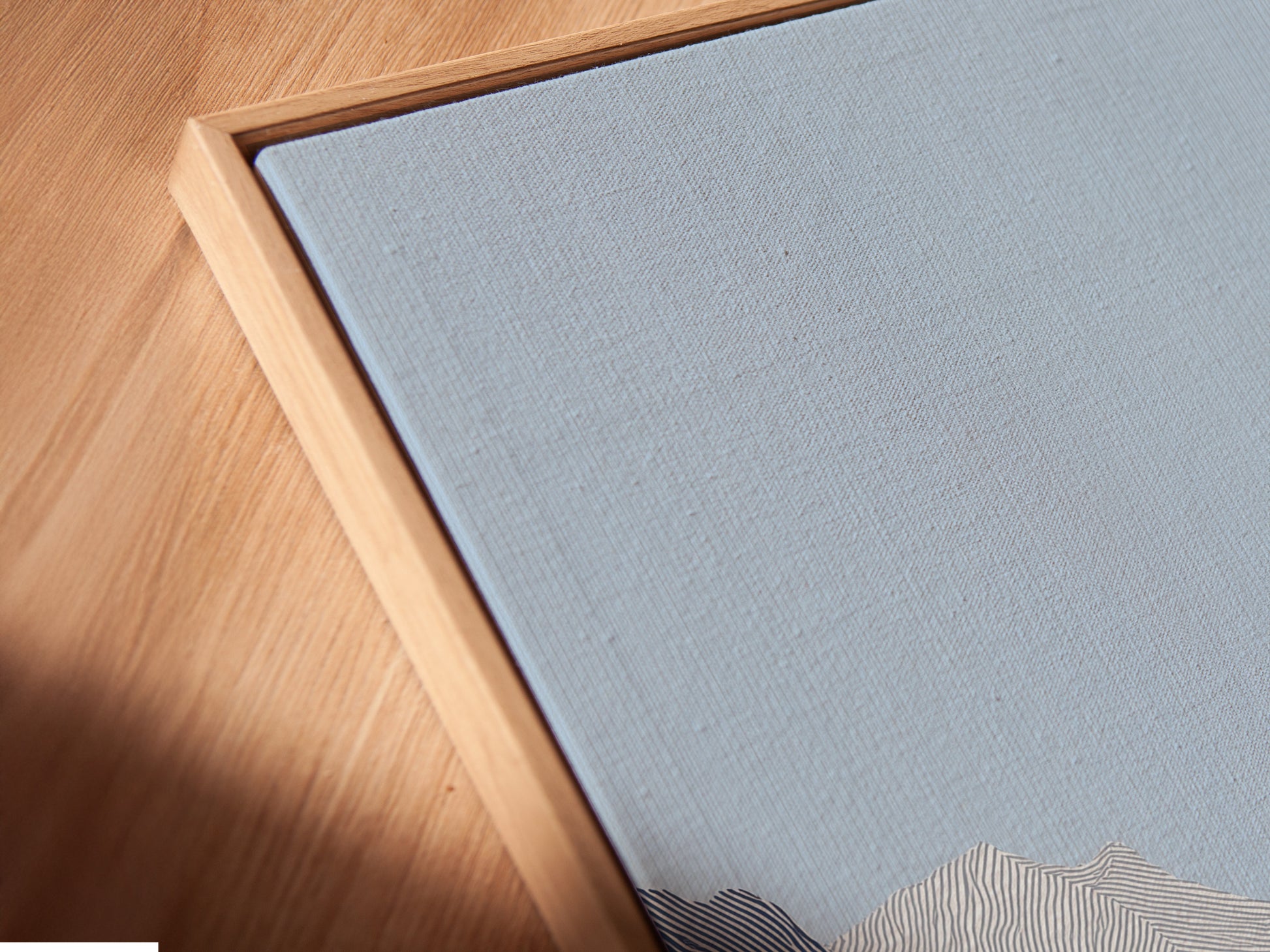 A close-up angled view of a canvas print in a floating frame. The floating frame gives the artwork a contemporary look. The canvas print showcases intricate details. The artwork appears to float within the frame. This art enhances the viewing experience.