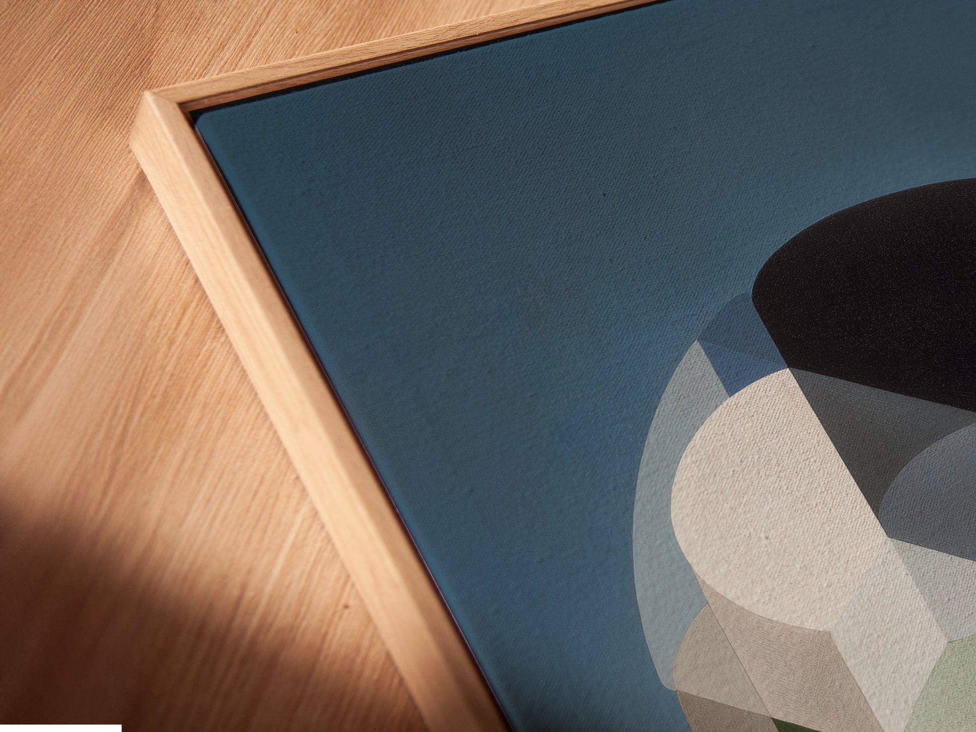 Angled close up of a canvas print in floating frame. The abstract artwork features a geometric print. Its perfect for adding a touch of mid century decor to your home. The retro wall art is perfect for contemporary spaces.