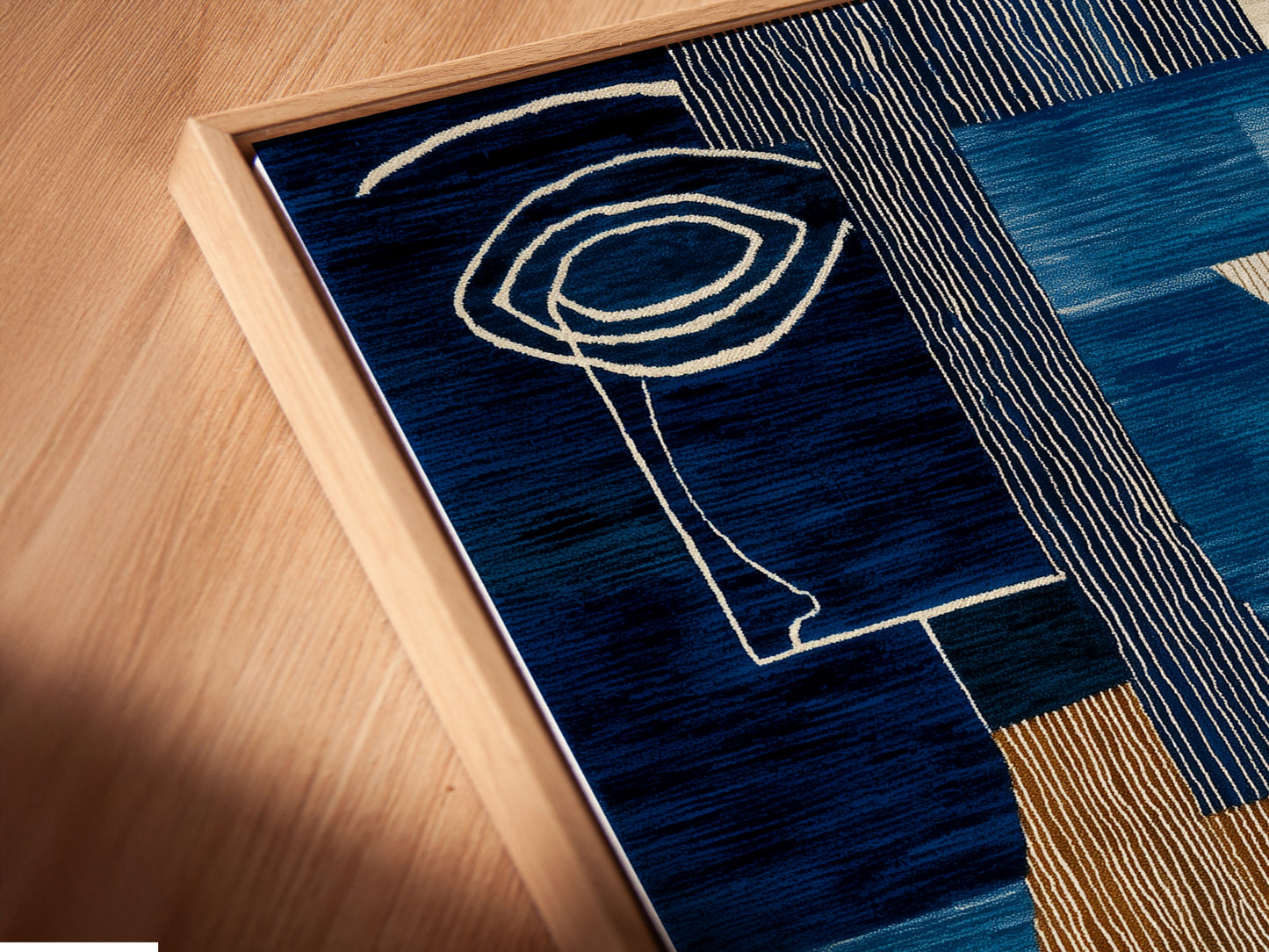 A close up of our canvas print in a floating frame. The abstract blue artwork features modern geometric shapes. It adds a contemporary touch to any space. Perfect for elevating your home or office decor. Explore our range of framed artwork today!