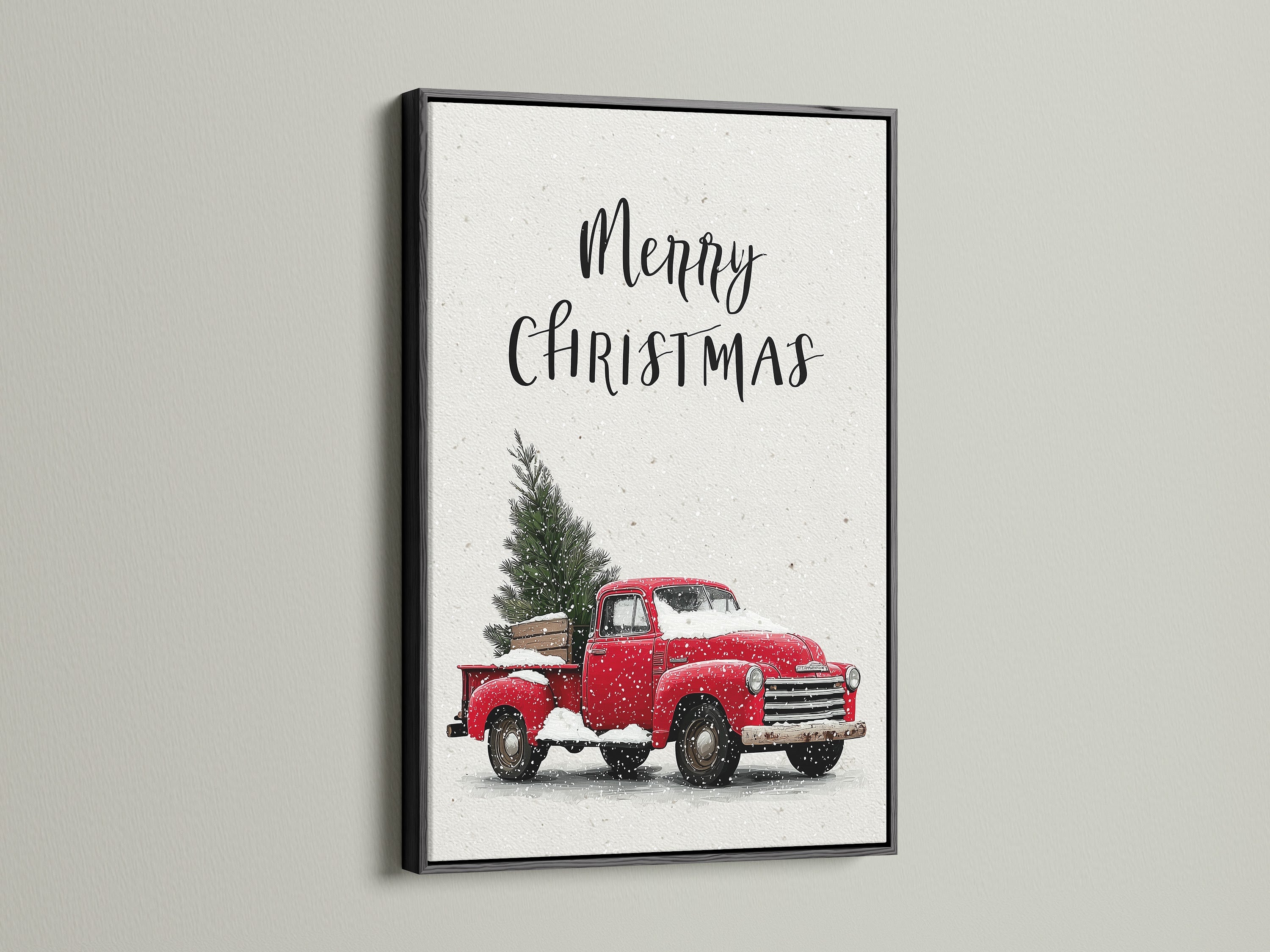 Artwork featuring a black frame. The artwork showcases a Christmas scene. A red truck is carrying a Christmas tree covered in snow. The black frame provides a bold classic contrast. It makes the artwork stand out. This art is perfect for seasonal home decor. It brings sophistication.