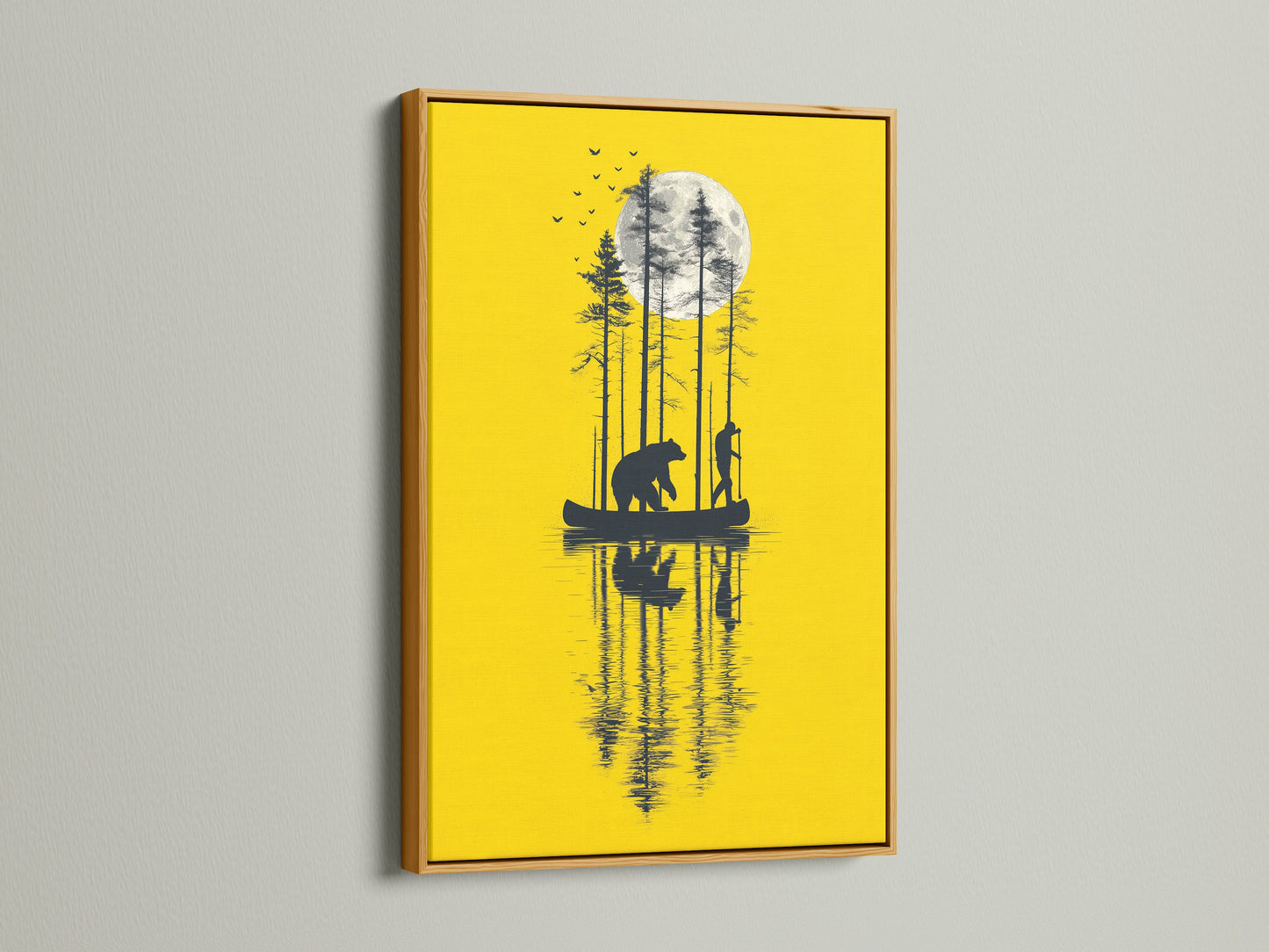 The bear and canoe yellow moon artwork stands out in a gold frame. This nature canvas print is a luxurious addition to any room. The silhouette art complements cabin wall decor. It is a unique moon art print for wildlife art collectors. The river art adds tranquility.