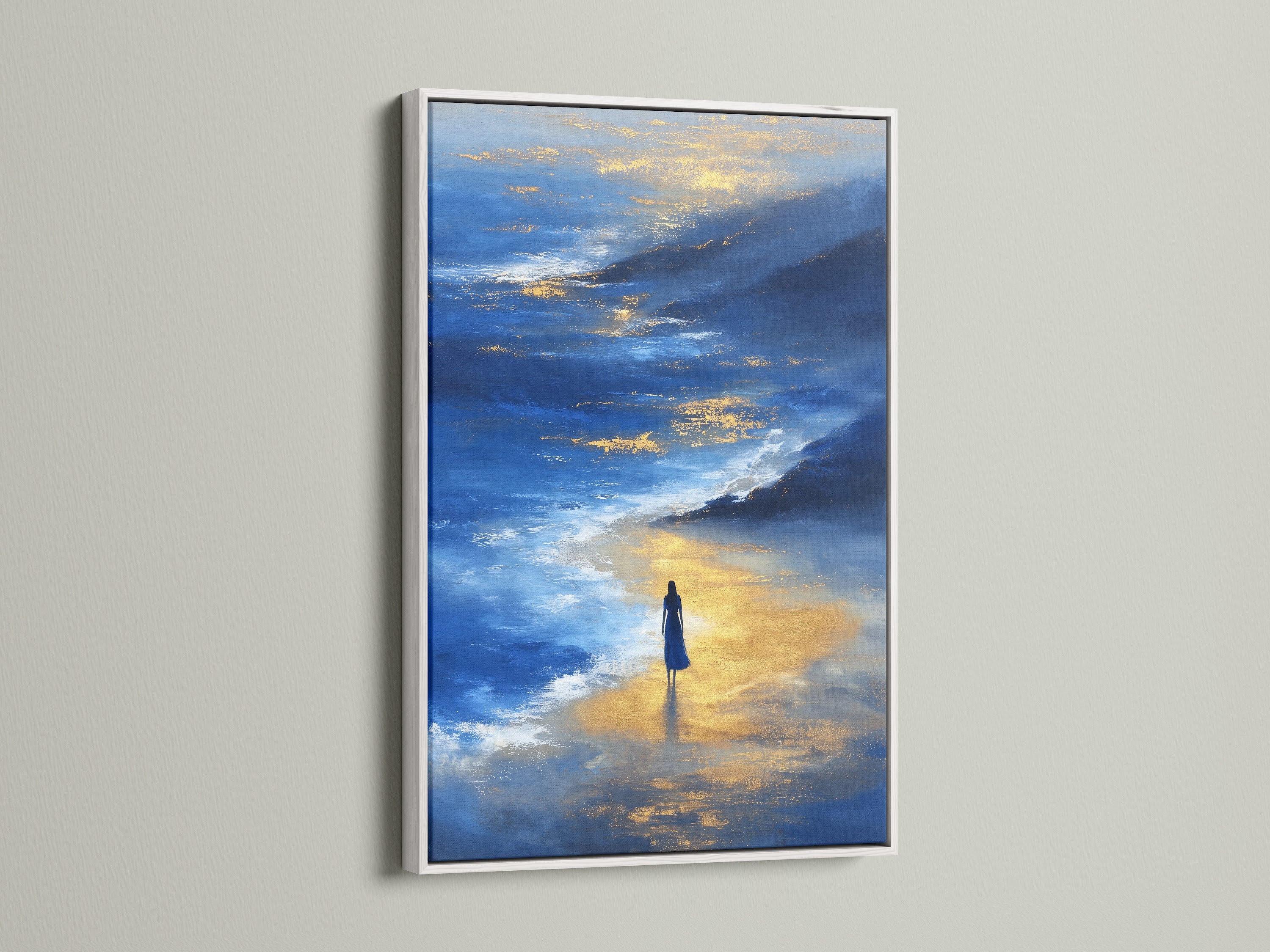 This Ocean Reflection Canvas Art is displayed in a white frame. The contrast highlights the blue and gold abstract seascape print. The artwork brings a serene and reflective quality to any room. Coastal wall decor suitable for living rooms and offices.
