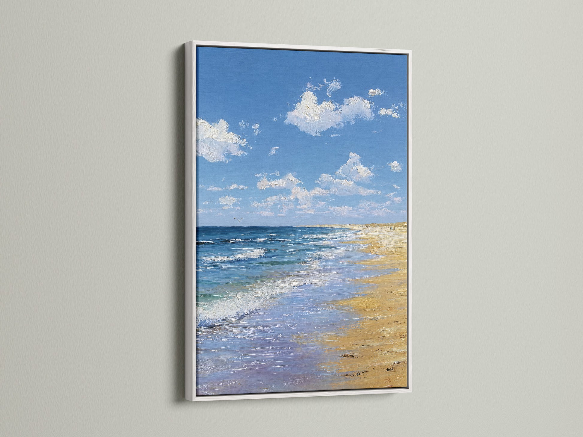 Artwork in a white frame. The artwork depicts a beach scene. The art is hanging on a white wall. The white frame provides a clean modern look. This artwork will enhance any living space.