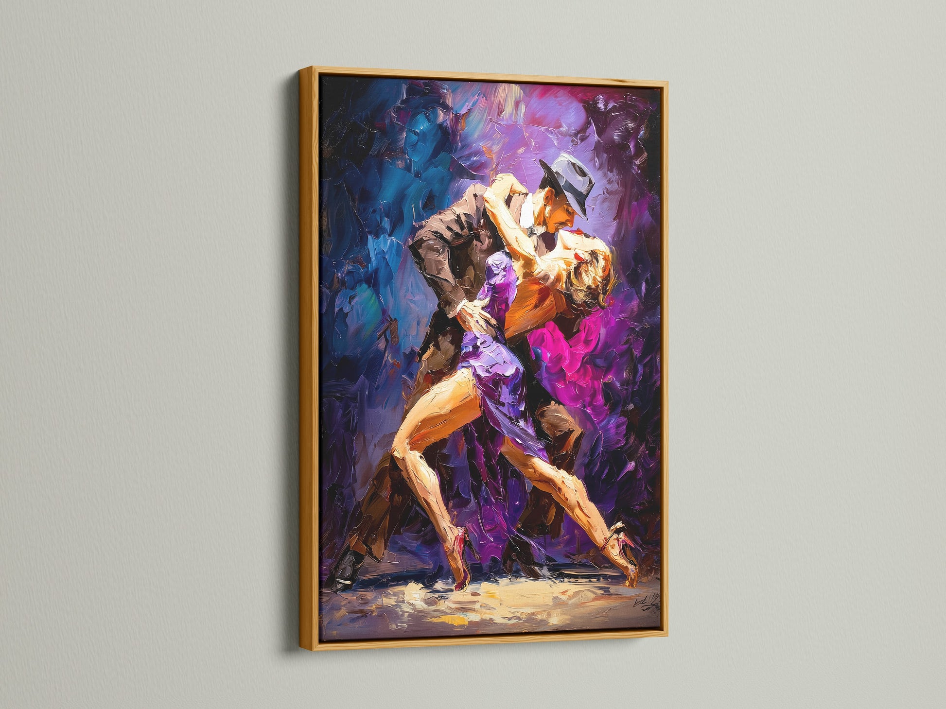 Framed artwork featuring a tango dance is displayed. The gold frame brings an elegant touch. The shimmering finish enhances the artwork. Bring luxury to your space with our gold framed artwork. Shop today.
