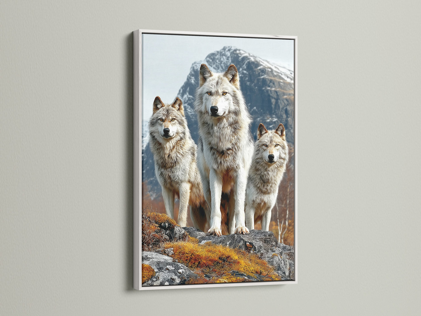 Wolf Pack artwork showcased in a white frame. This wildlife wall art complements mountain landscapes. It is suited for a light interior. The white frame enhances the rustic home art's details. Discover nature's charm.