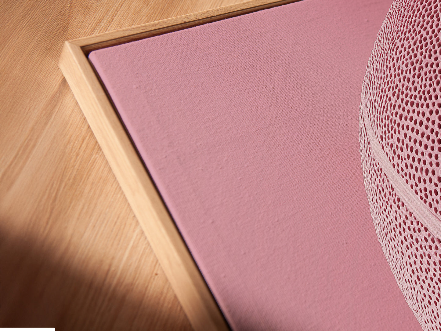 Angled close up of a canvas print in a floating frame. The floating frame creates a modern and minimalist look. The canvas print appears to float within the frame. This enhances the artwork and adds depth to the display.