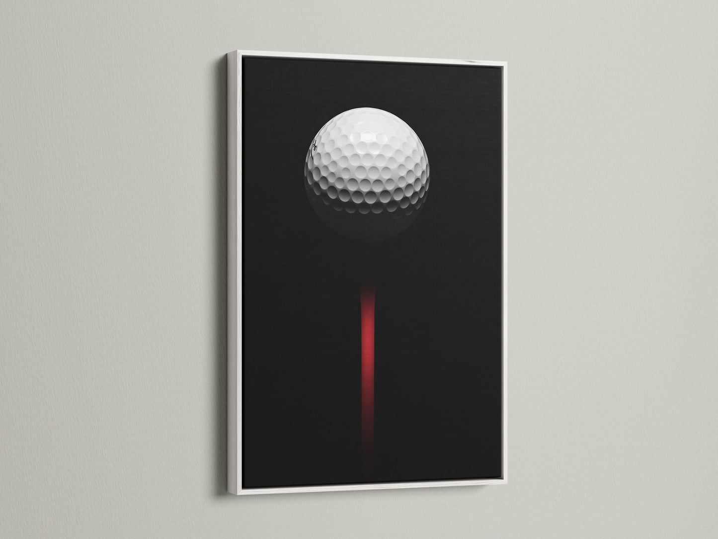Golf ball artwork displayed in a white frame. This minimalist golf art is perfect for a modern space. The black and red colors add a touch of sophistication. A great golf lover gift.