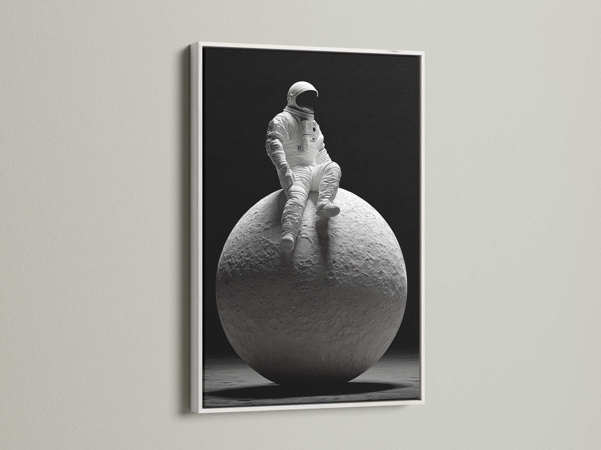This striking art print shows an astronaut sitting atop the moon. The artwork is presented in a clean white frame. A white frame offers a minimalist aesthetic. It allows the artwork to stand out and become a focal point.