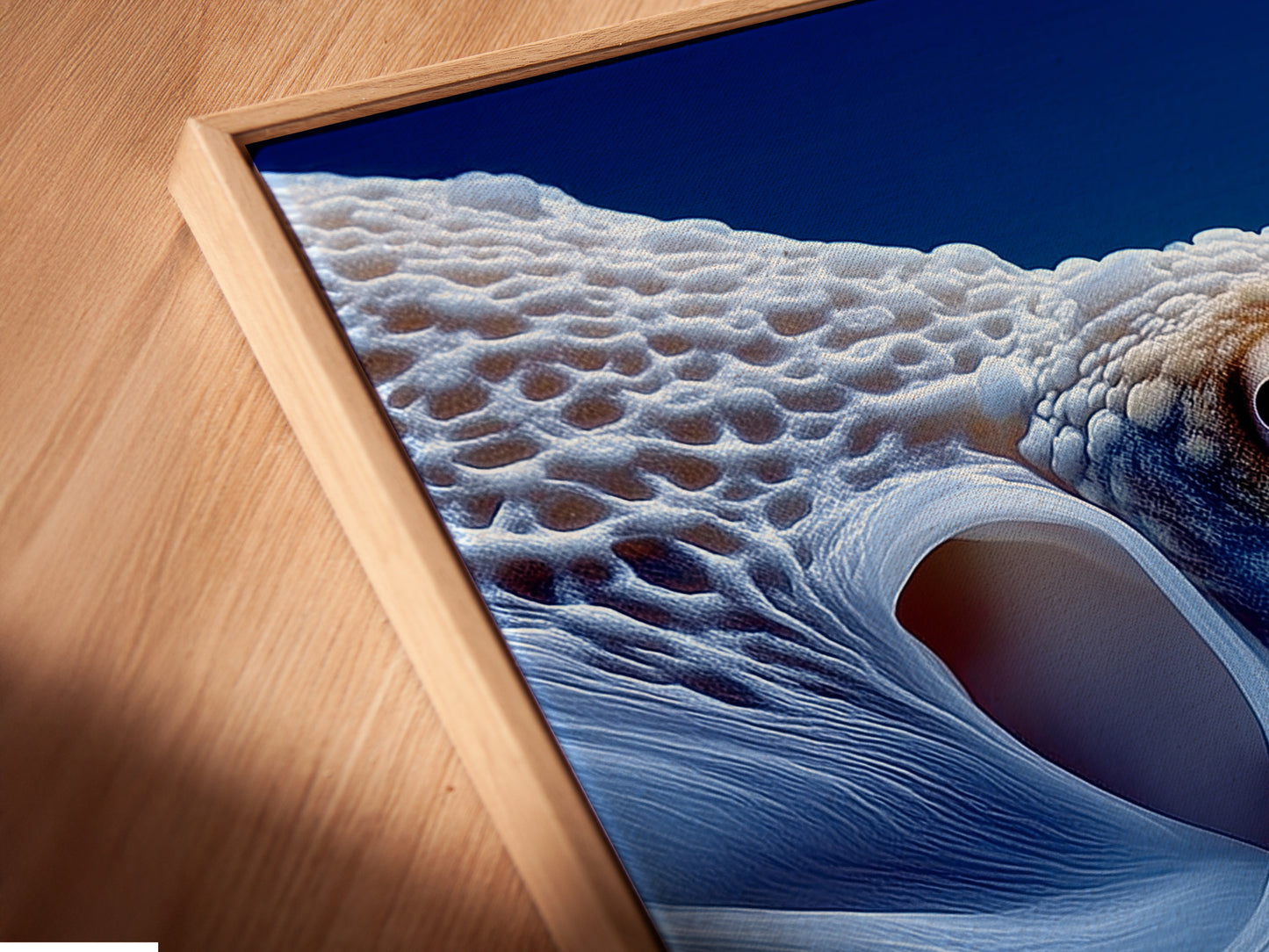 A close-up shot reveals an octopus canvas print in a floating frame. The frame gives the artwork a modern and airy feel. The abstract ocean art appears to float on the wall. This unique presentation enhances the beauty of the sea creature art. It is perfect for contemporary spaces.