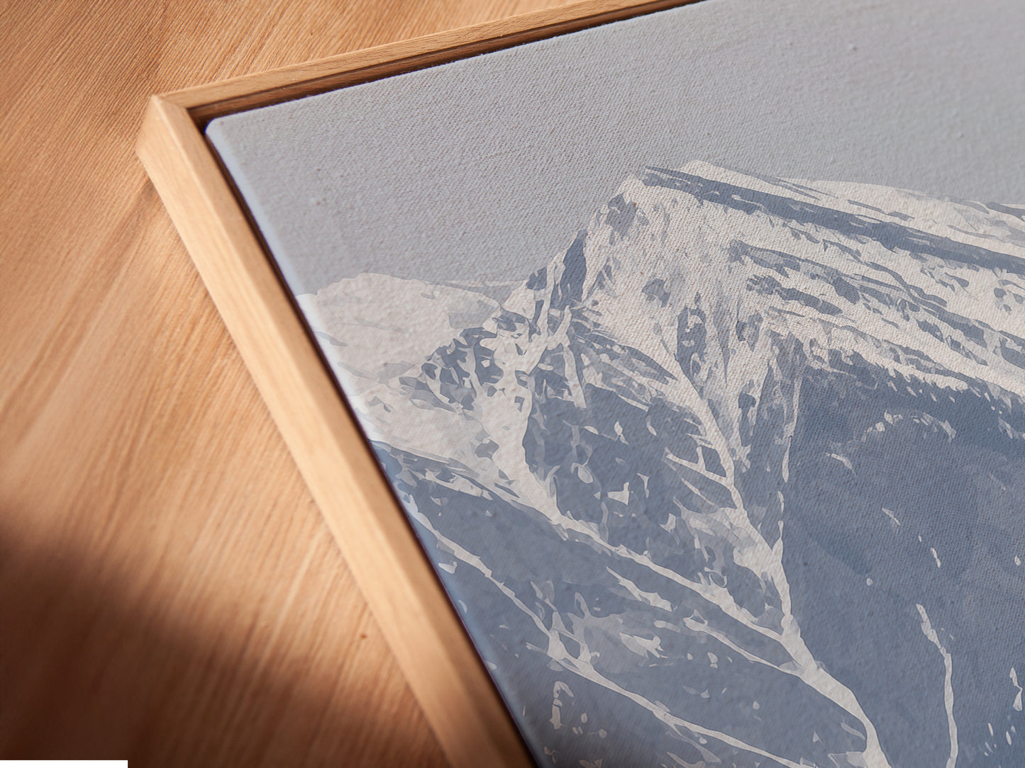 A close-up angled view reveals a canvas print in a floating frame. The mountain flower artwork features a snowy peak landscape. It is a modern decor piece for any room. The lilac flowers add a touch of wilderness art to your walls.