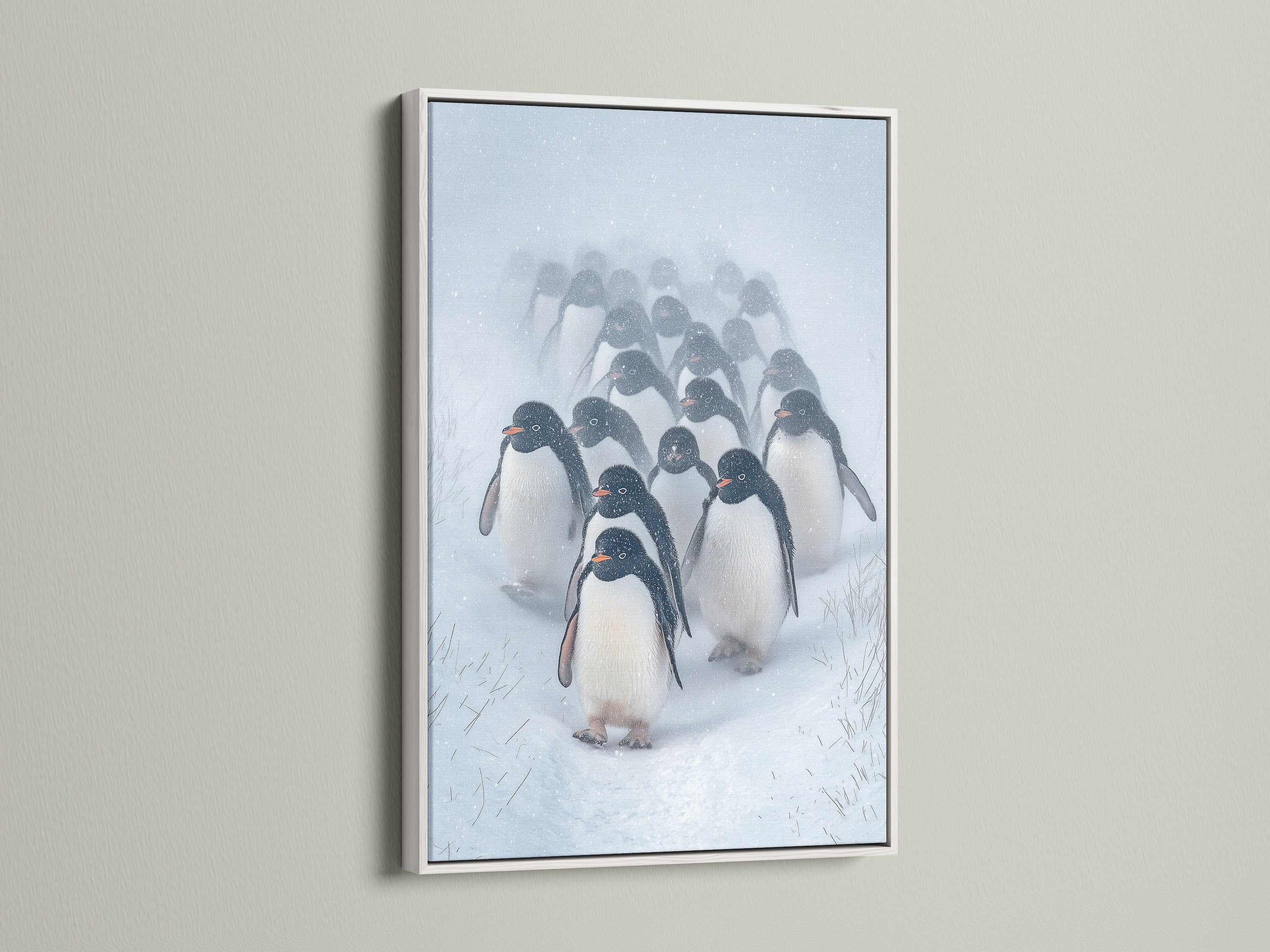 Penguin Parade artwork showcased in a white frame. The bright white enhances the snow scene in the antarctic print. This animal art print is perfect for nursery wall art or a Scandinavian-style living room. A serene winter wall decor choice.