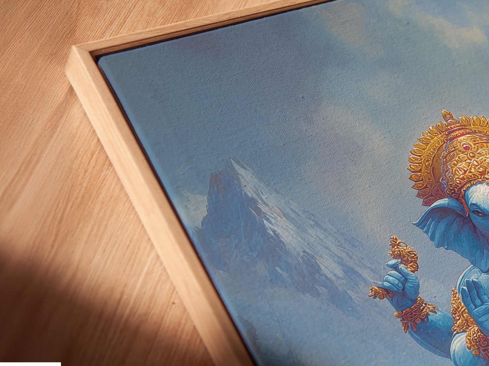 Close up of a canvas print in a floating frame. The artwork features Ganesha a Hindu God. The art is perfect for meditation rooms. Consider this for yoga studio decor. The blue spiritual artwork is calming and serene.