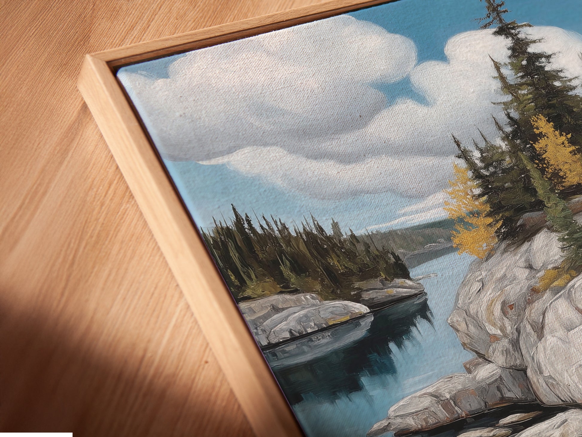 Get a detailed view of this canvas print in a floating frame. The angled close-up highlights the texture and craftsmanship. The lake landscape artwork adds a touch of sophistication. This is perfect for living rooms or waiting rooms.