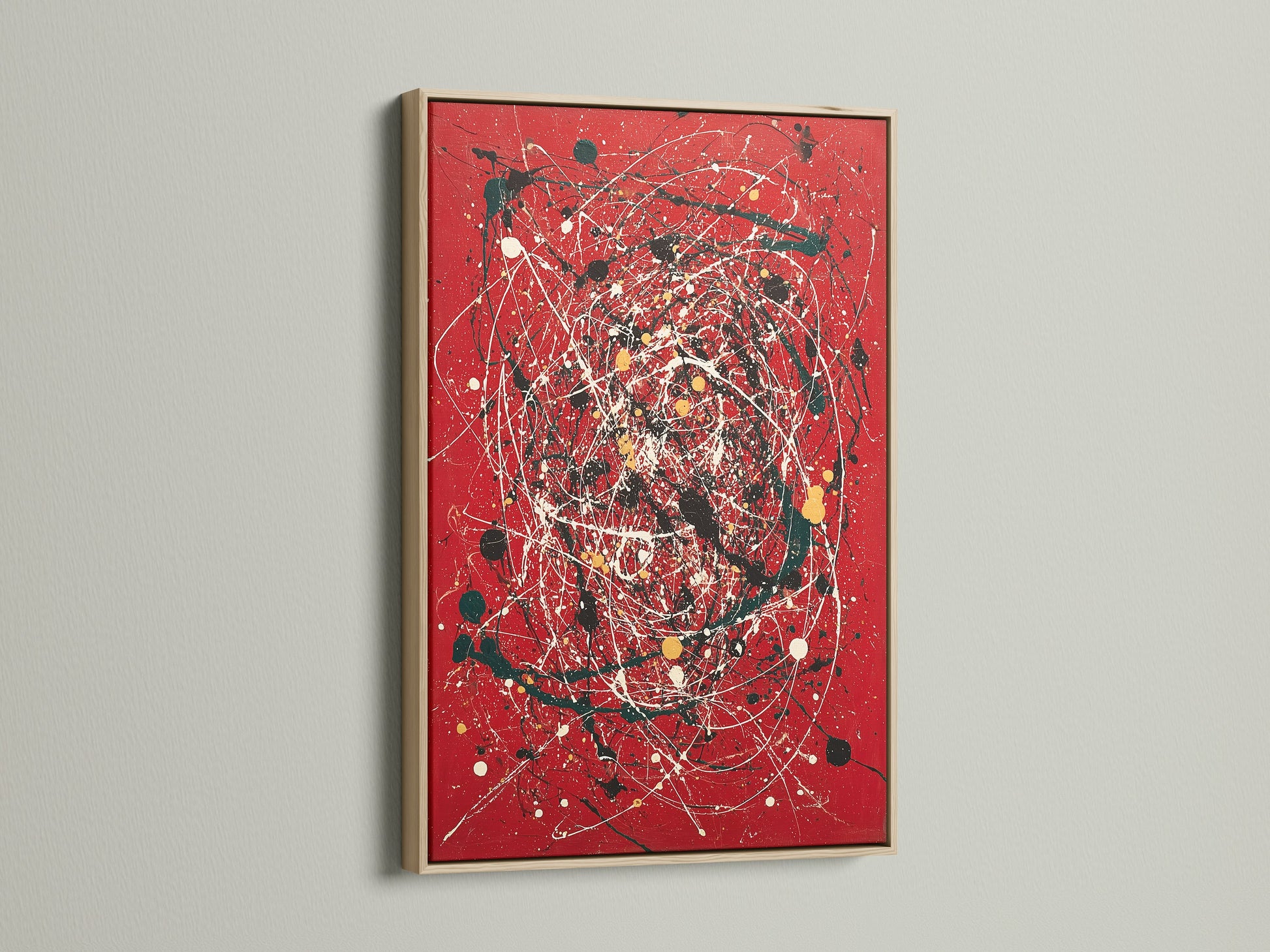 A striking red canvas print featuring abstract wall art. The artwork is beautifully framed in oak. This modern piece uses splatter art and paint drips for a contemporary look. Ideal for adding a bold statement to any room. Perfect for those seeking modern home art.
