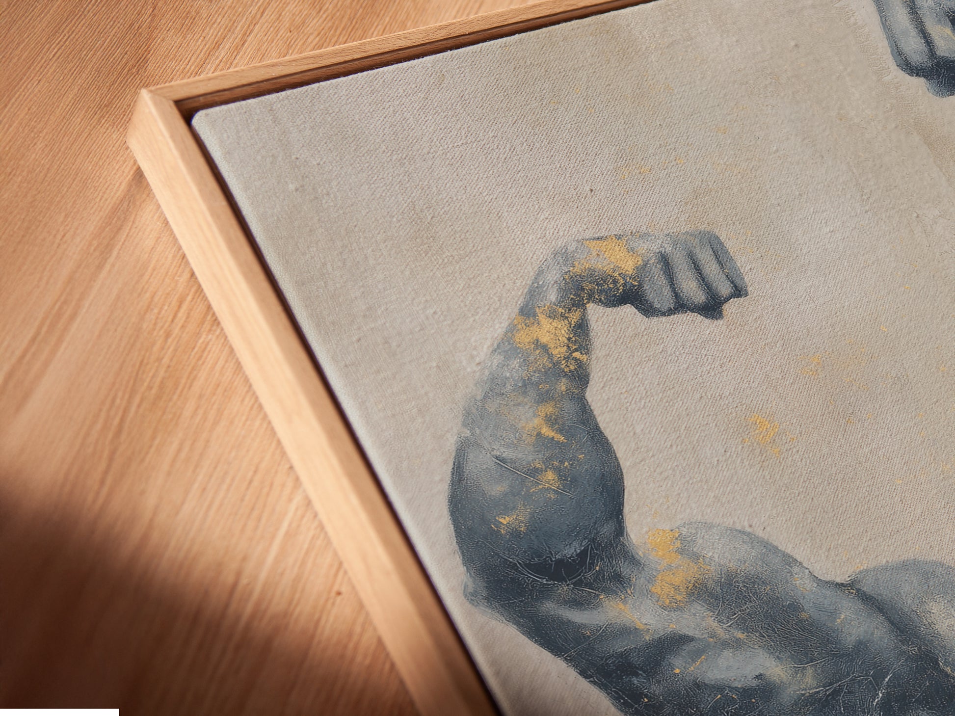 Close-up of a canvas print in a floating frame. The bodybuilder art has gray and gold tones. A modern piece of fitness decor. Ideal for gym wall art or a unique trainer gift. See the fine details.