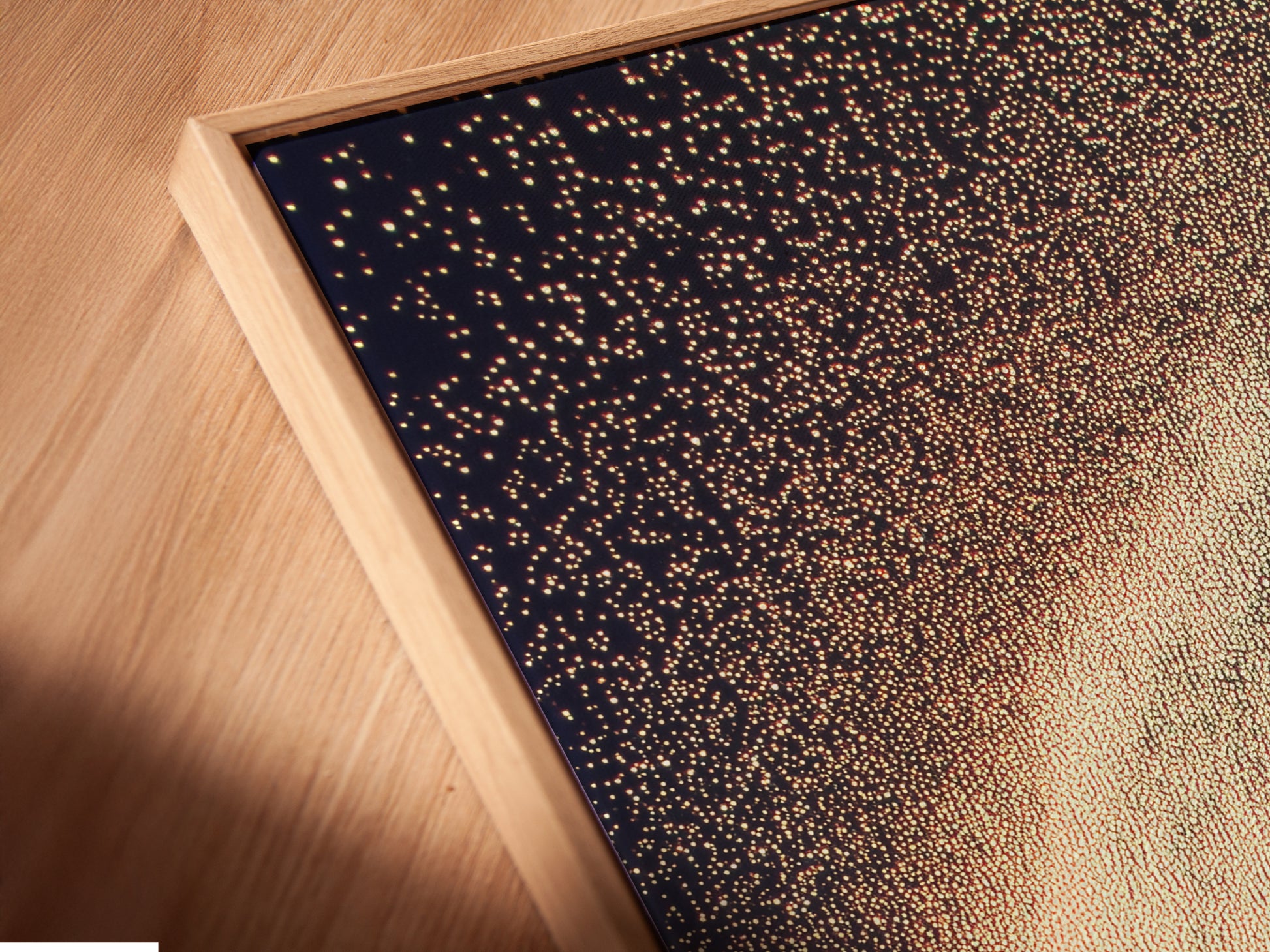 Close-up of a celestial canvas print in a floating frame. The abstract family artwork adds a modern touch to any room. The cosmic sparkle poster is perfect for kids room wall decor. This dreamy wall art enhances studios lobbies and clinics. Elevate your space with this elegant framed artwork.