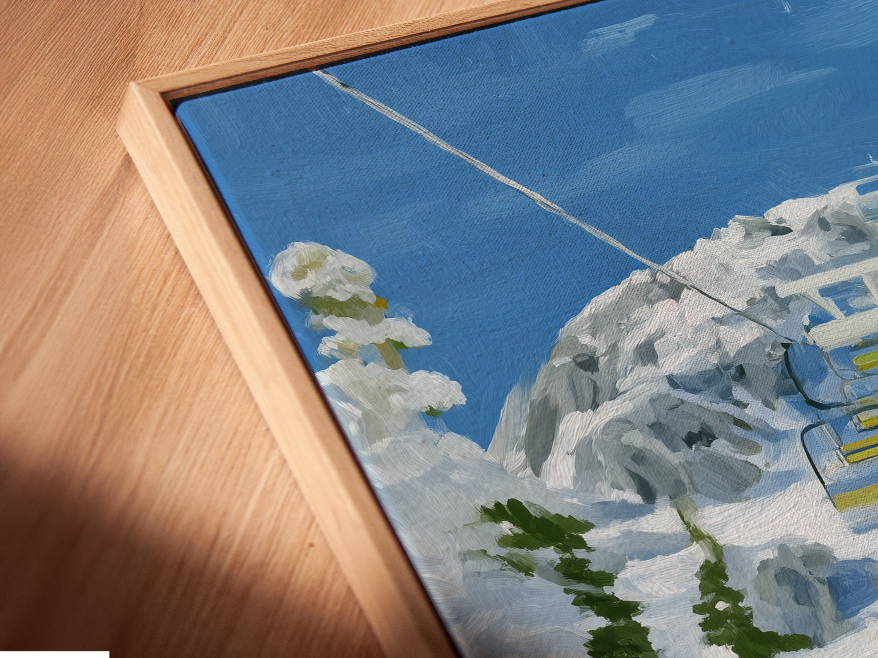 Close up of a canvas print in a floating frame. The Ski Lift artwork brings a winter mountain scene indoors. Wildflowers add a pop of color. A stylish piece for lodge or mountain themed spaces.